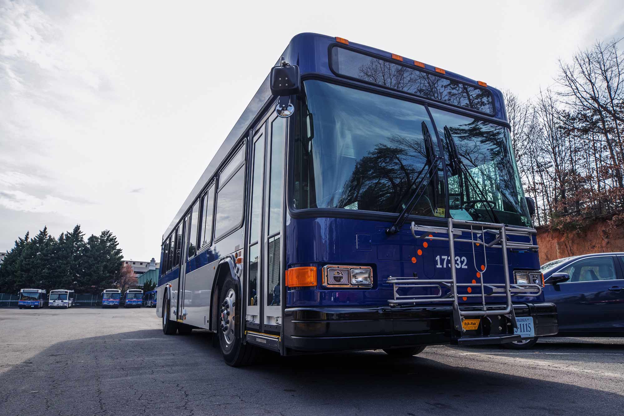 A University of Virginia bus drives through a parking lot