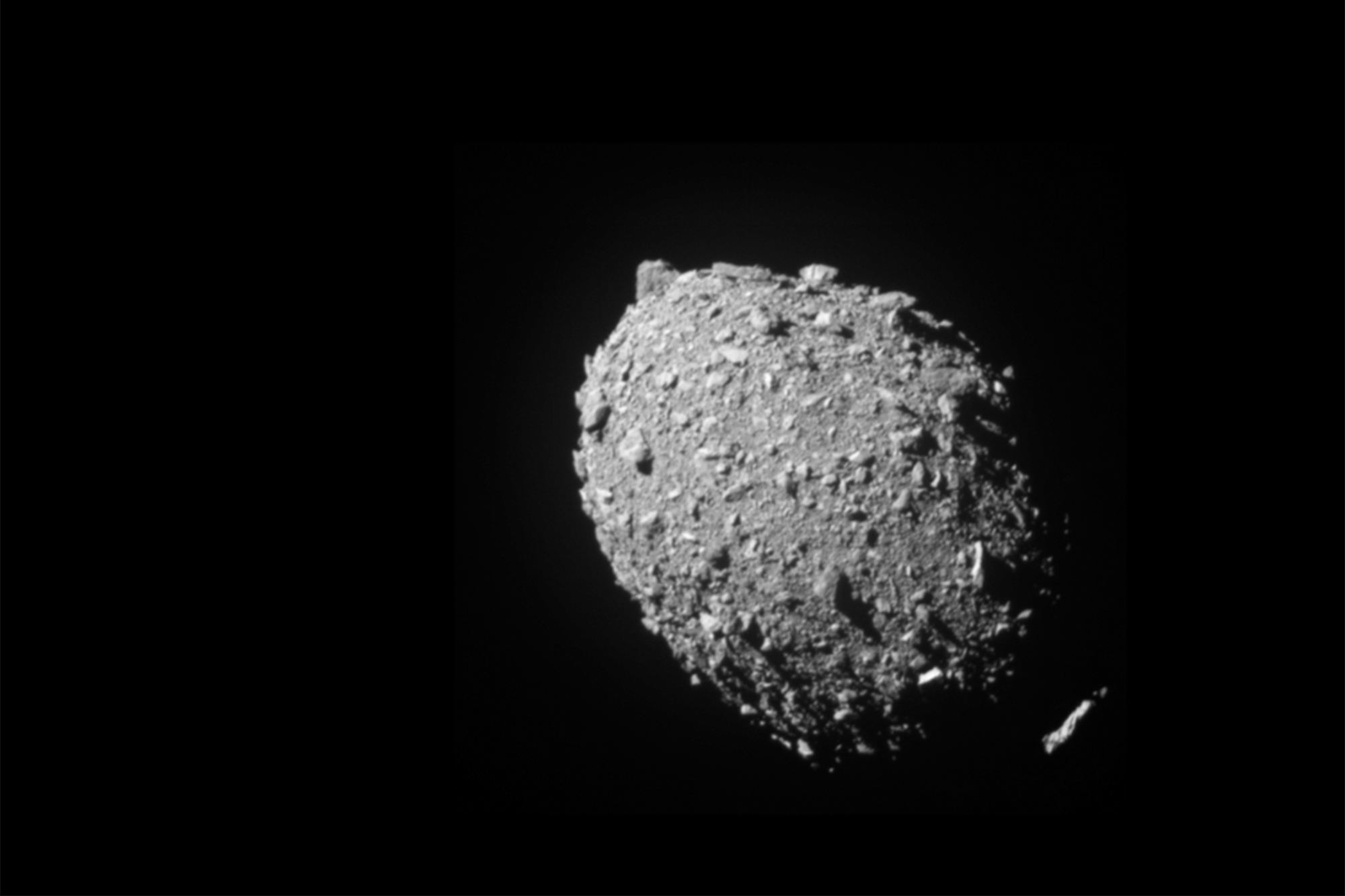 A rocky, egg shaped asteroid floating in space