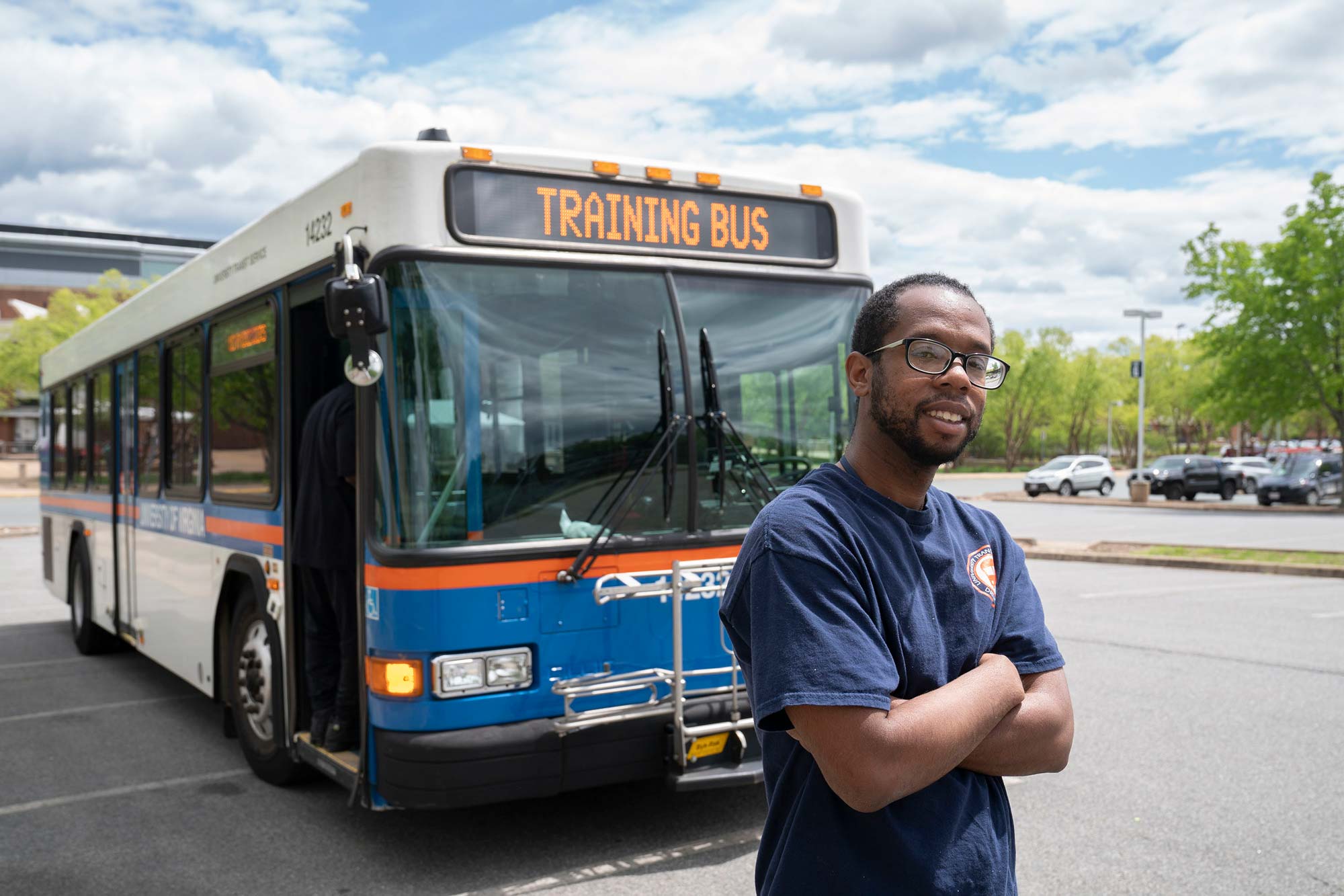 RaeJon Curry standing in front of a Charlottesville Area Transit bus