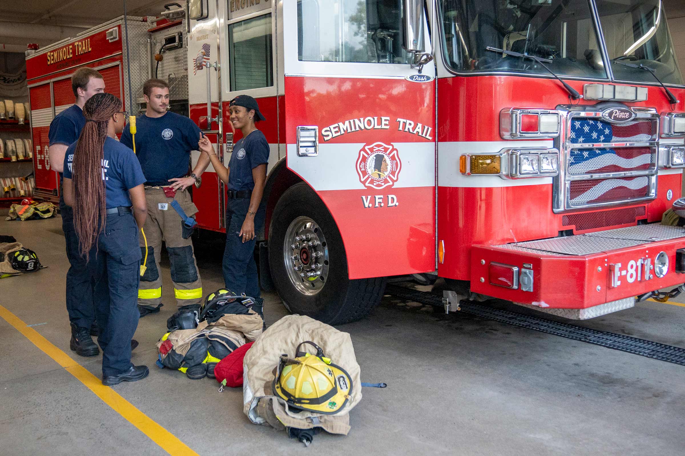 Volunteer firefighters Jones, Sasha Lawrence, Mannix Green and Tayah Mack in one of the bays at the Seminole Trail Volunteer Fire Department.