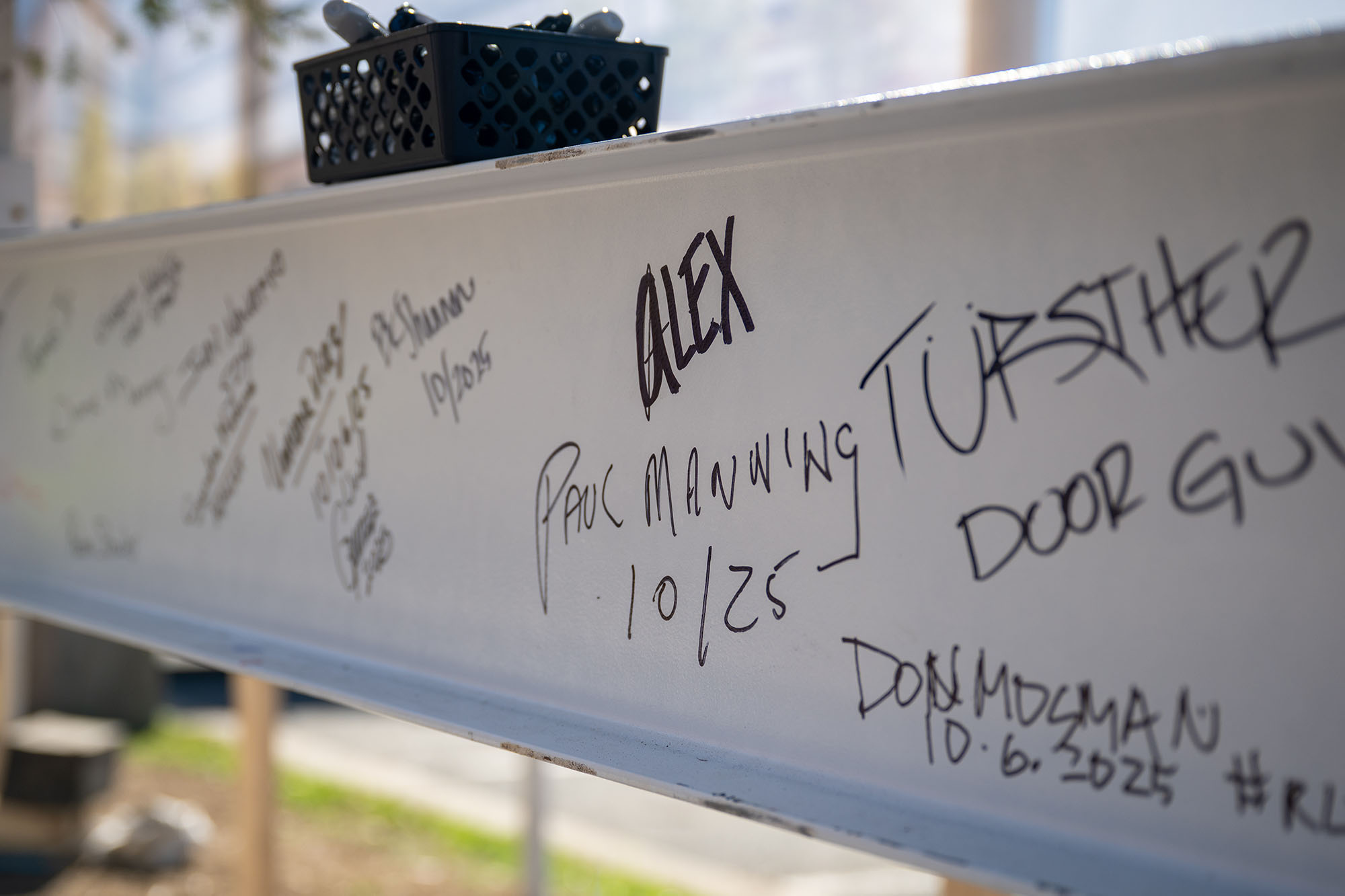 This image shows the names of well-wishers and project supporters affixed to the final beam.