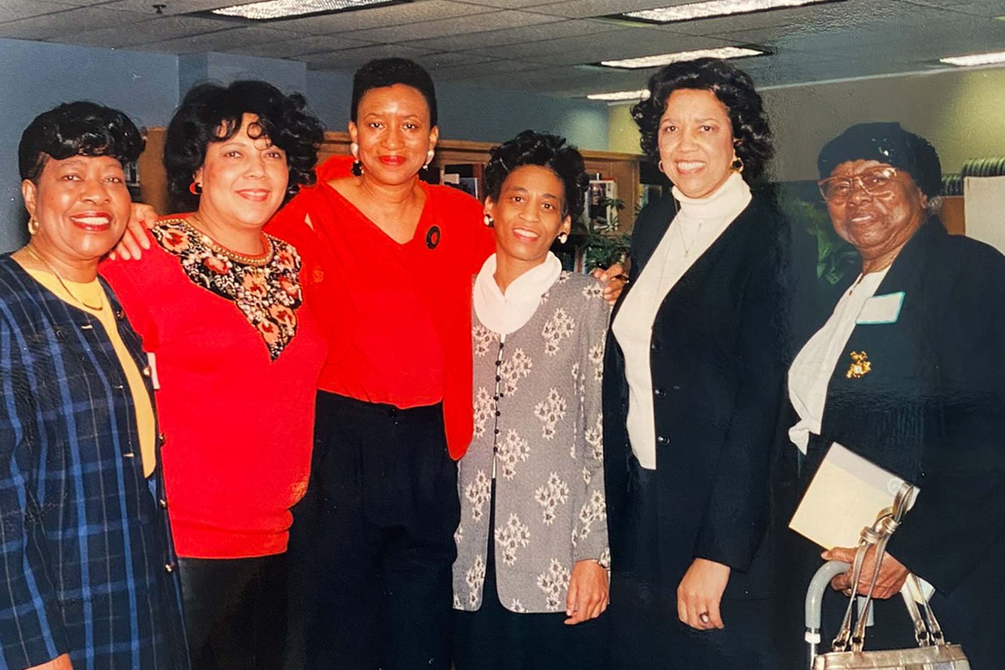 McDowell posing with group of teachers.