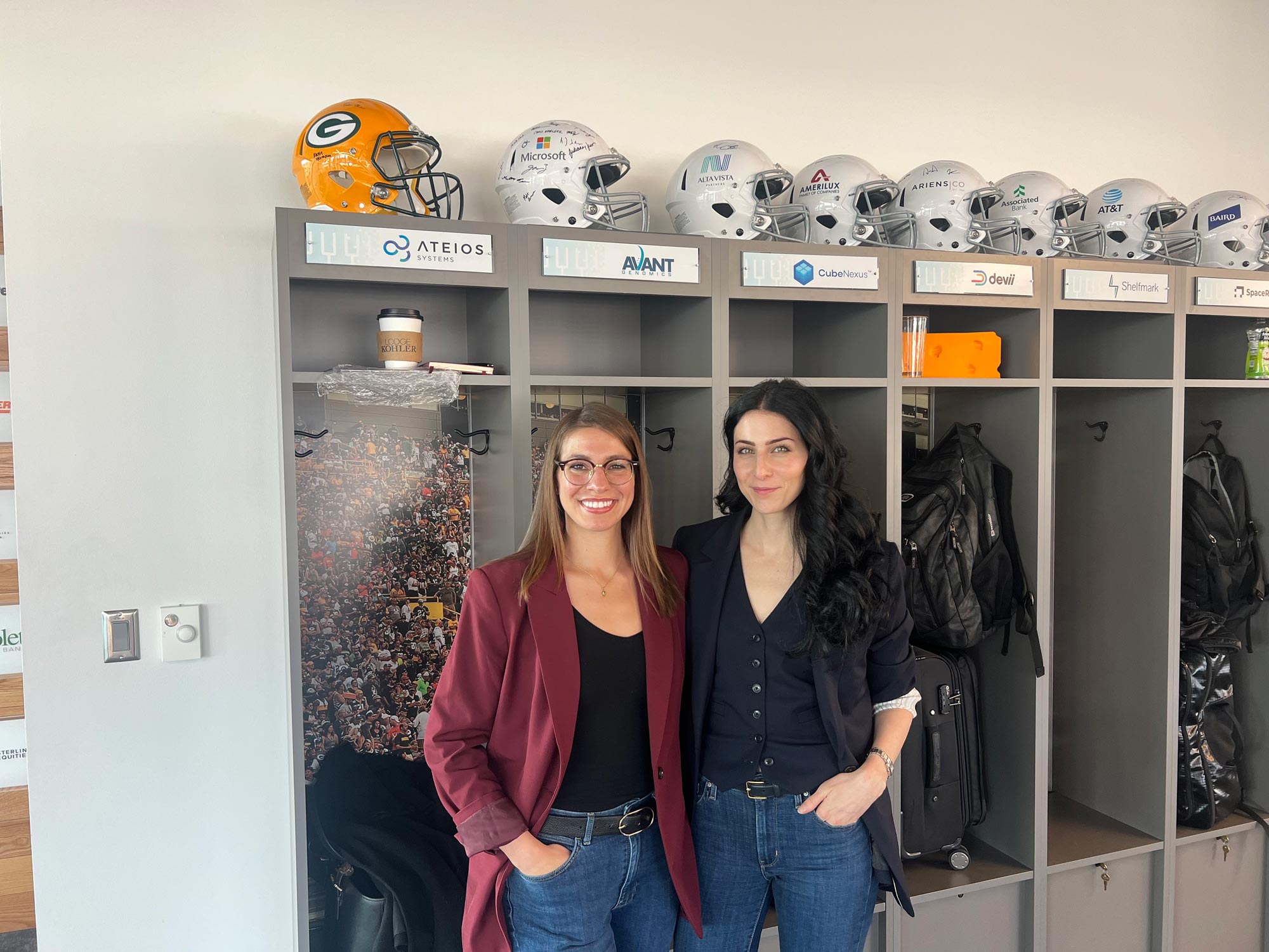 Portrait of Renna Nouwairi (left) and Rachelle Turiello (right) stand in the locker room at Lambeau Field in Green Bay