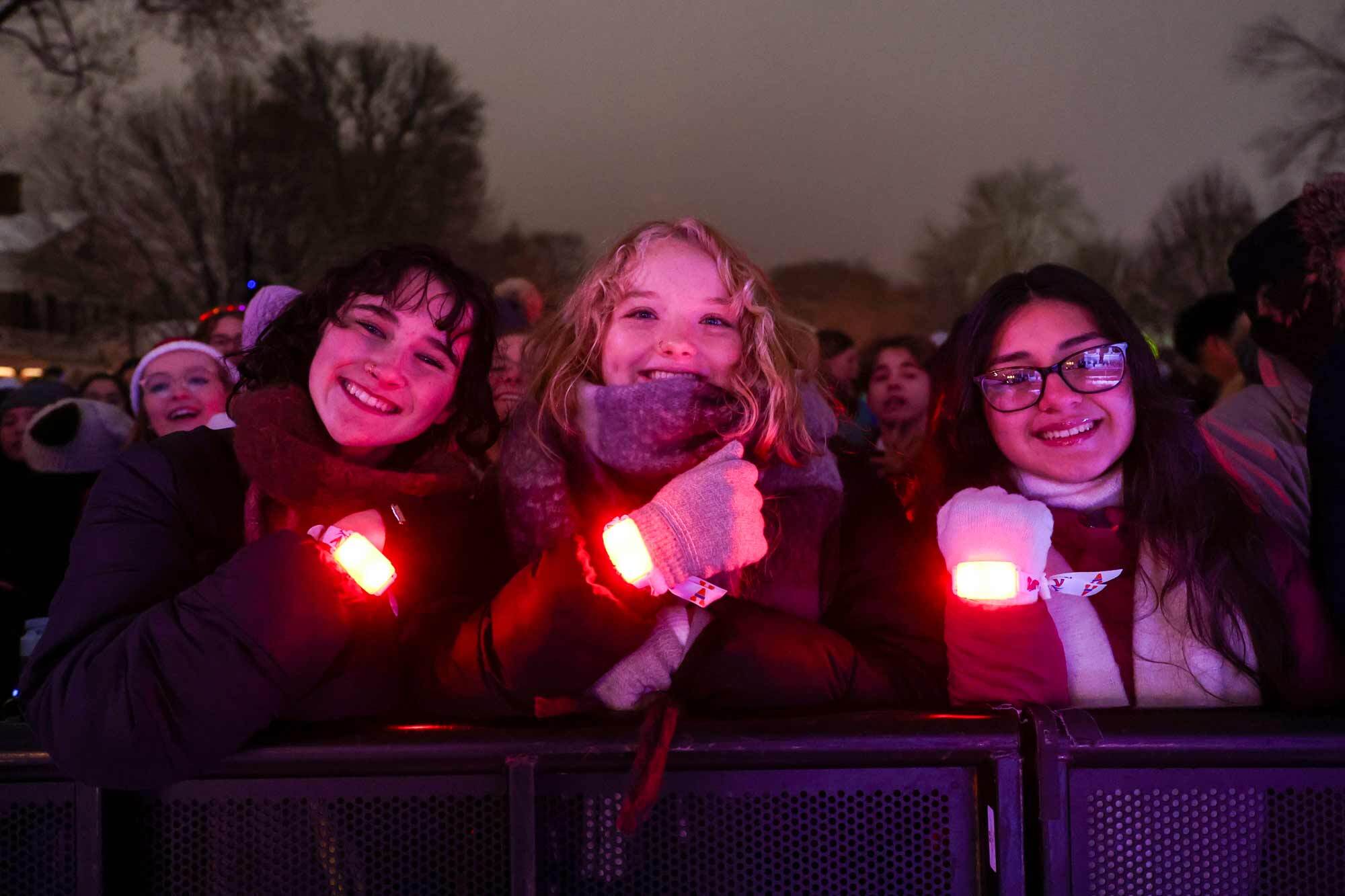 Nicole O’Keefe, Jaci Blackenship and Helen Hernandez holding up their light-up wristbands during LOTL 2025.