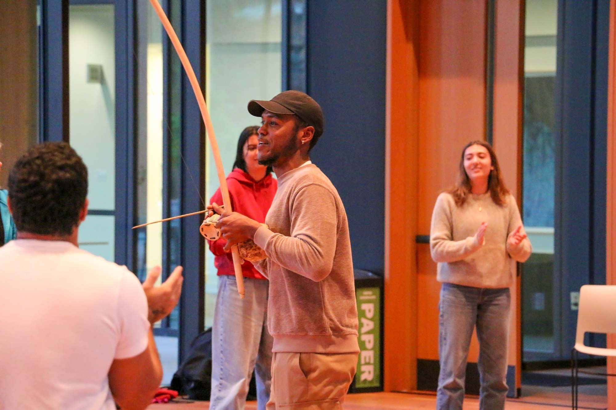 Mestre Onirê playing music for attendees during a workshop.
