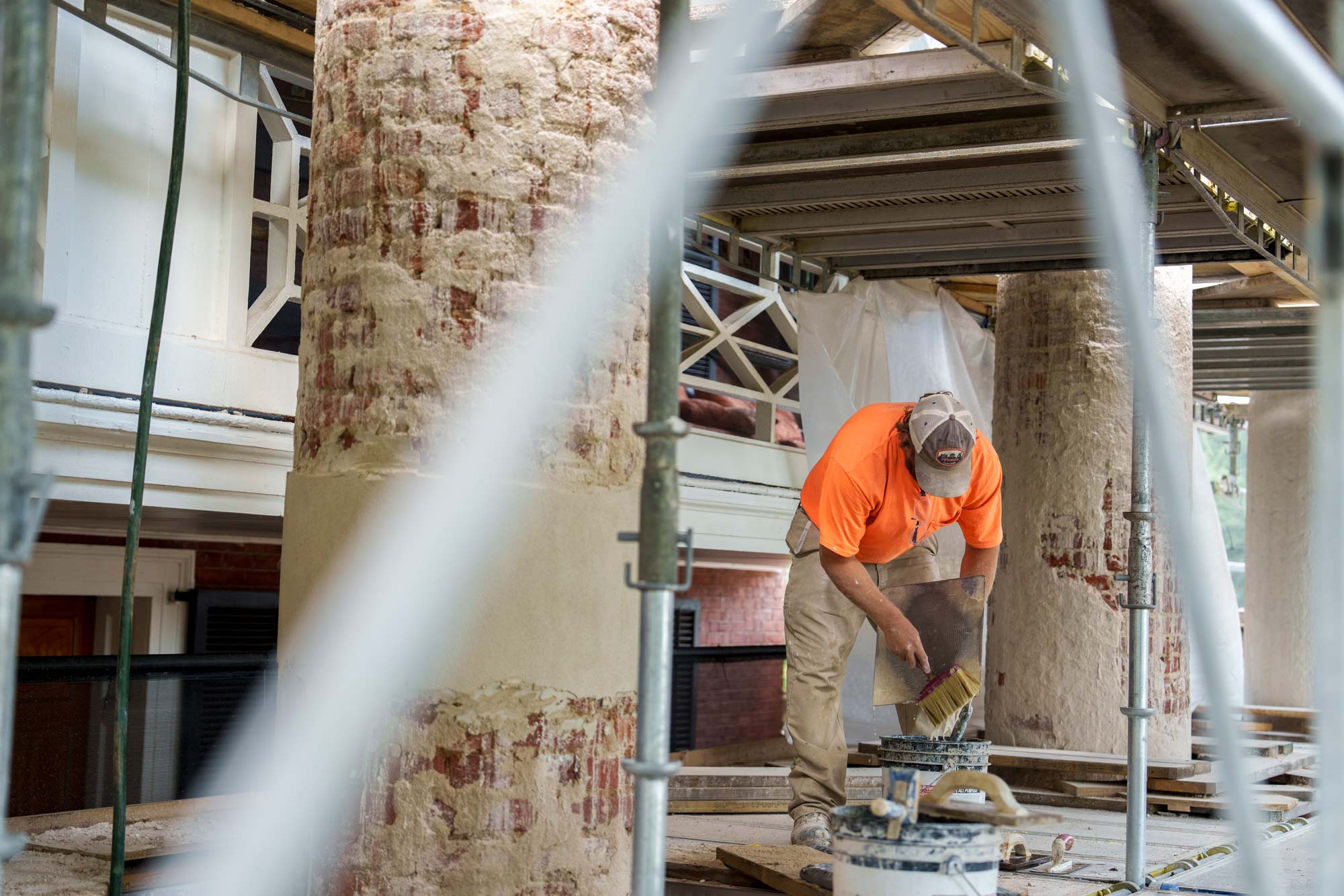 Robby Kolb mixing lime render to restore columns on UVA Pavillion 1