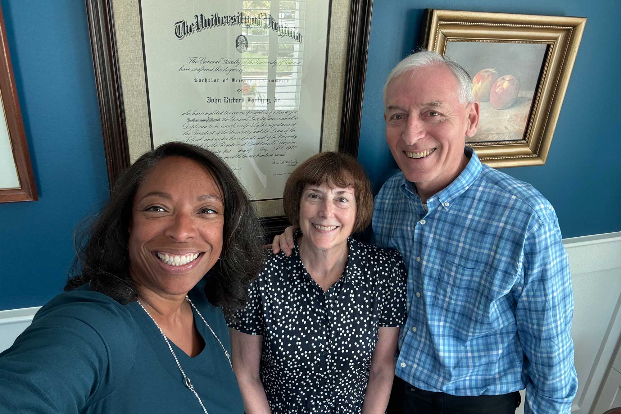 Group portrait of McIntire School Dean Nicole Thorne Jenkins with Mary Beth and Jack Banbury.