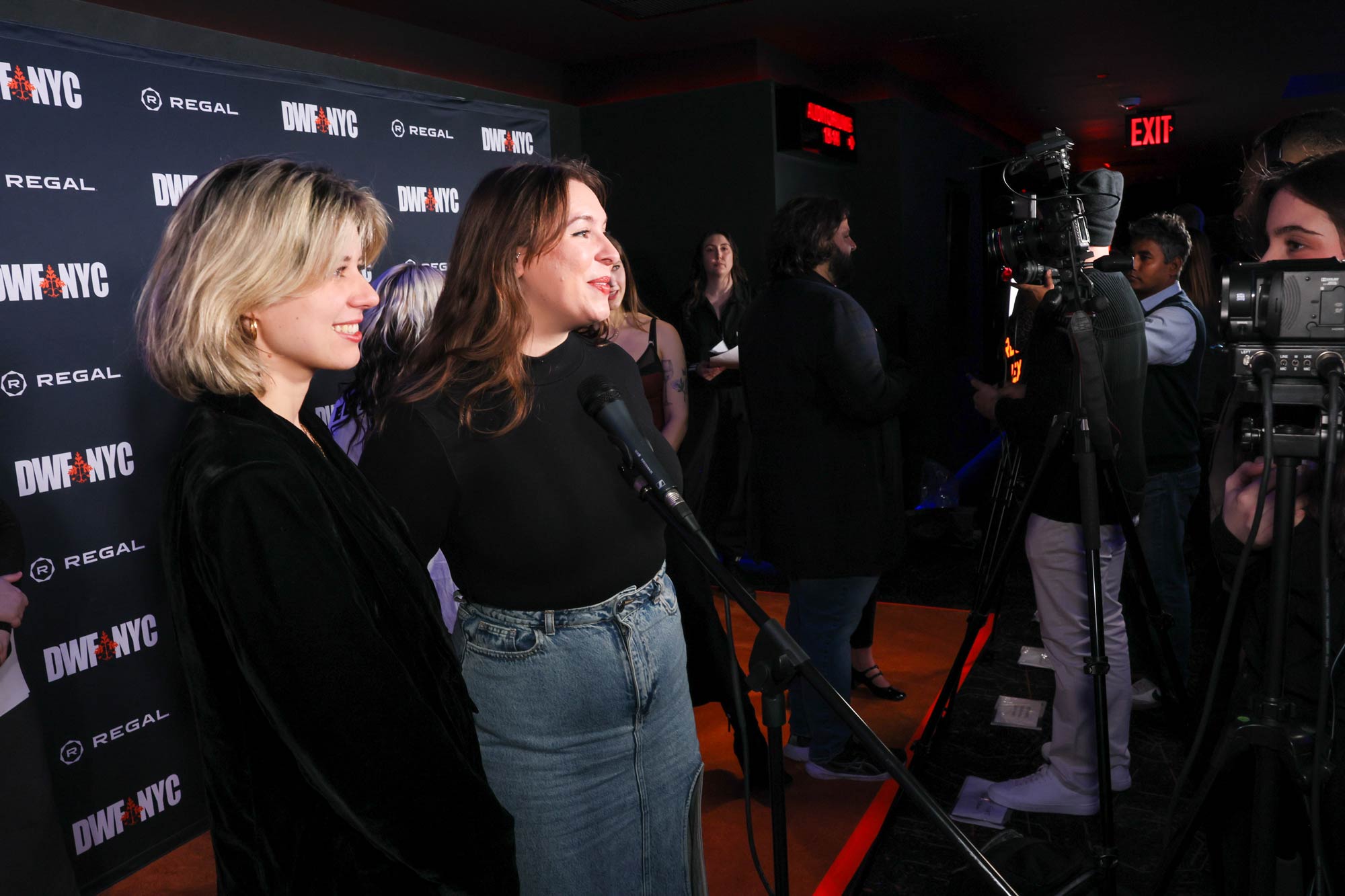 Candid photo of Emily Dhue on the red carpet at a film festival