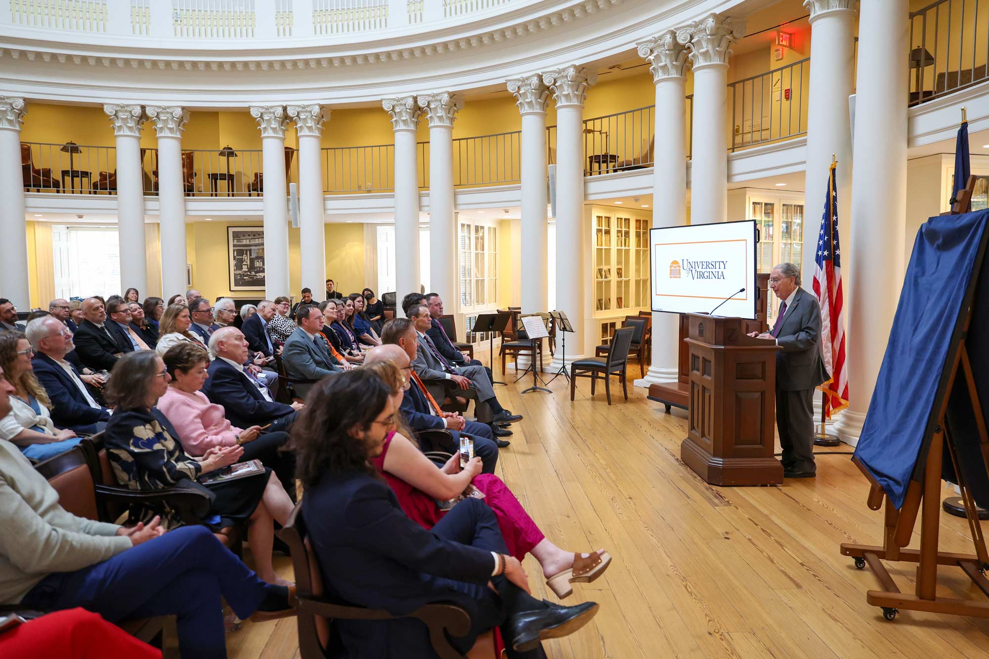 Joe Erdman at the podium talking to a full audience in the Rotunda dome room