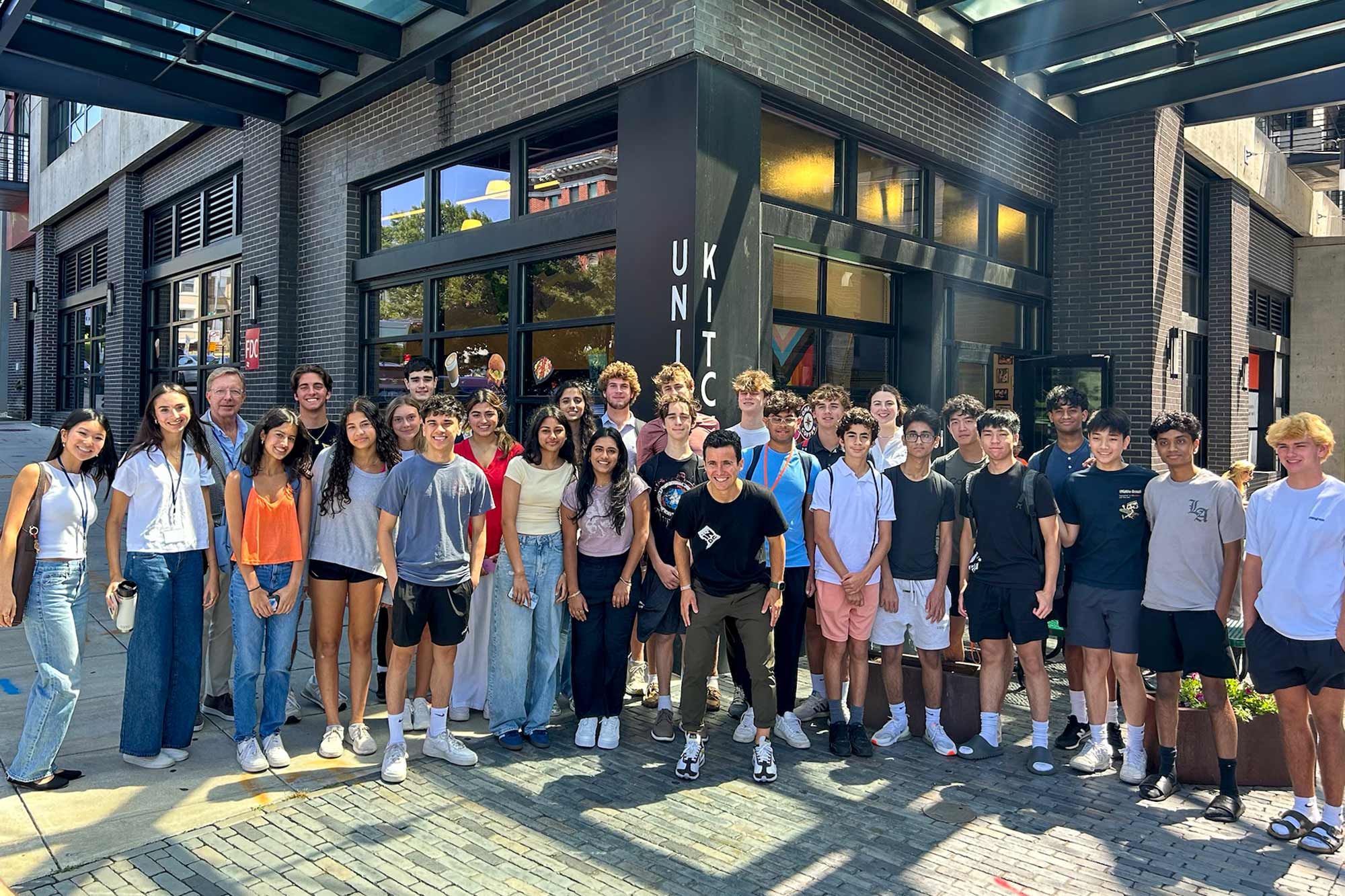 group picture of students in front of a restaurant