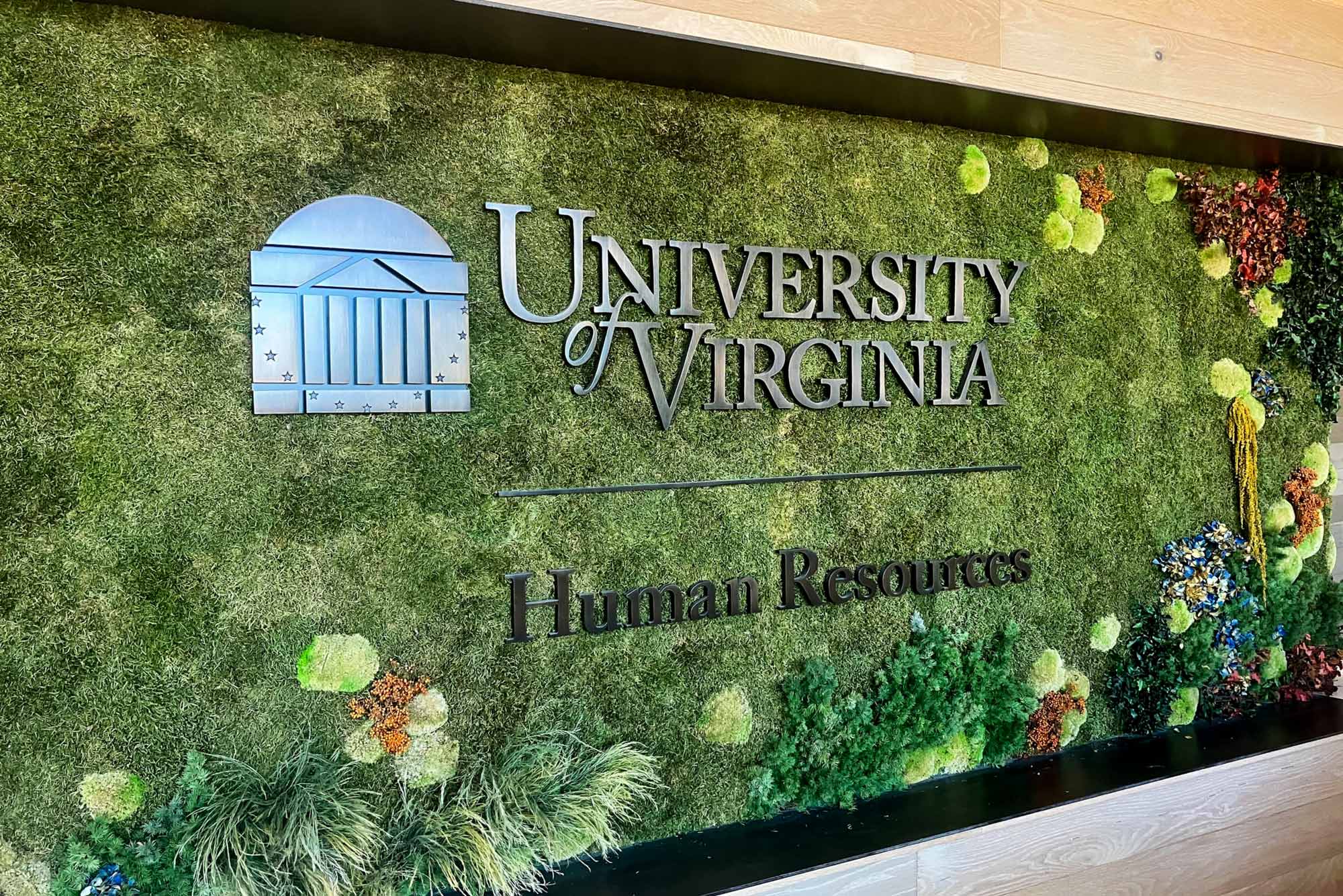 a sign covered in living plants reading University of Virginia | Human Resources