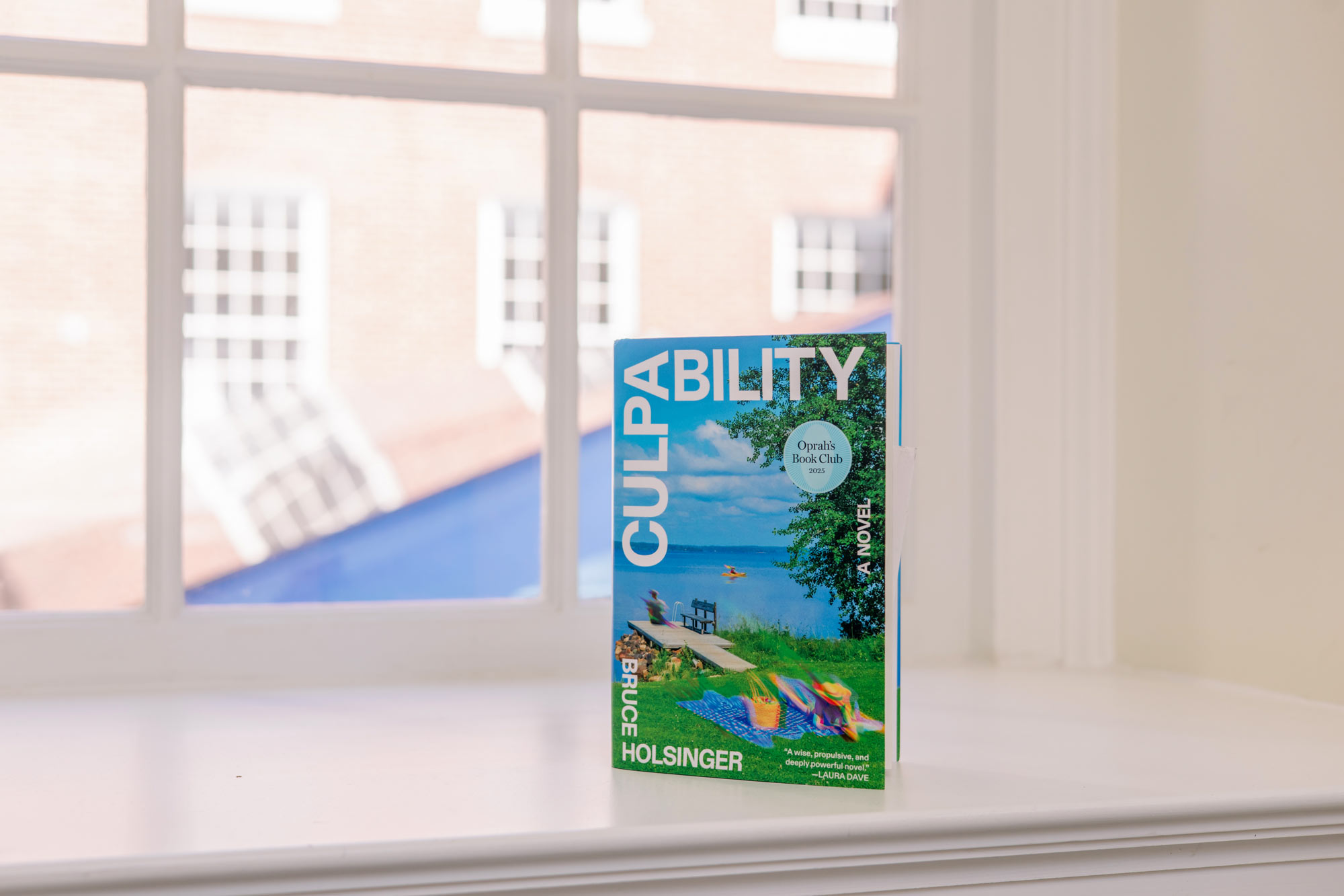 a copy of ‘Culpability‘ by Bruce Holsinger standing in a window sill