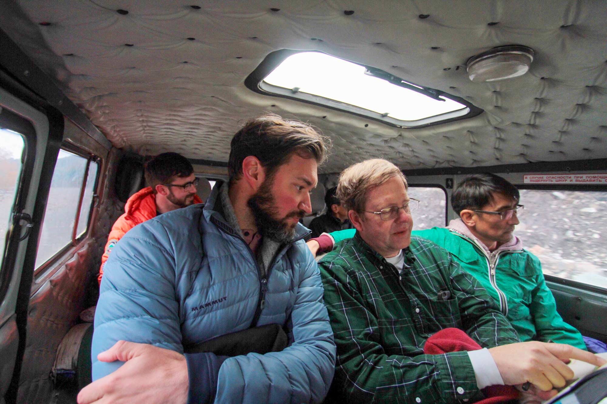 Dr. Jade Nunez consulting with a colleague while riding in a vehicle in Mongolia