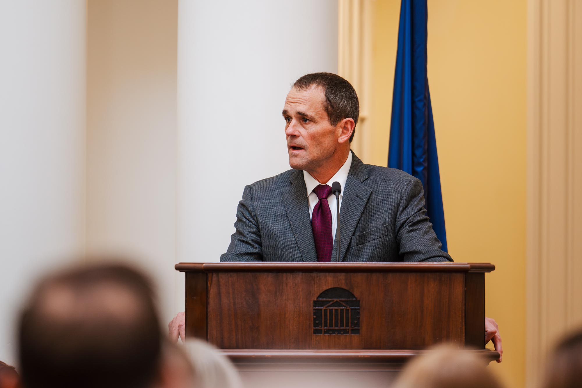President Jim Ryan speaking behind a podium in the Rotunda