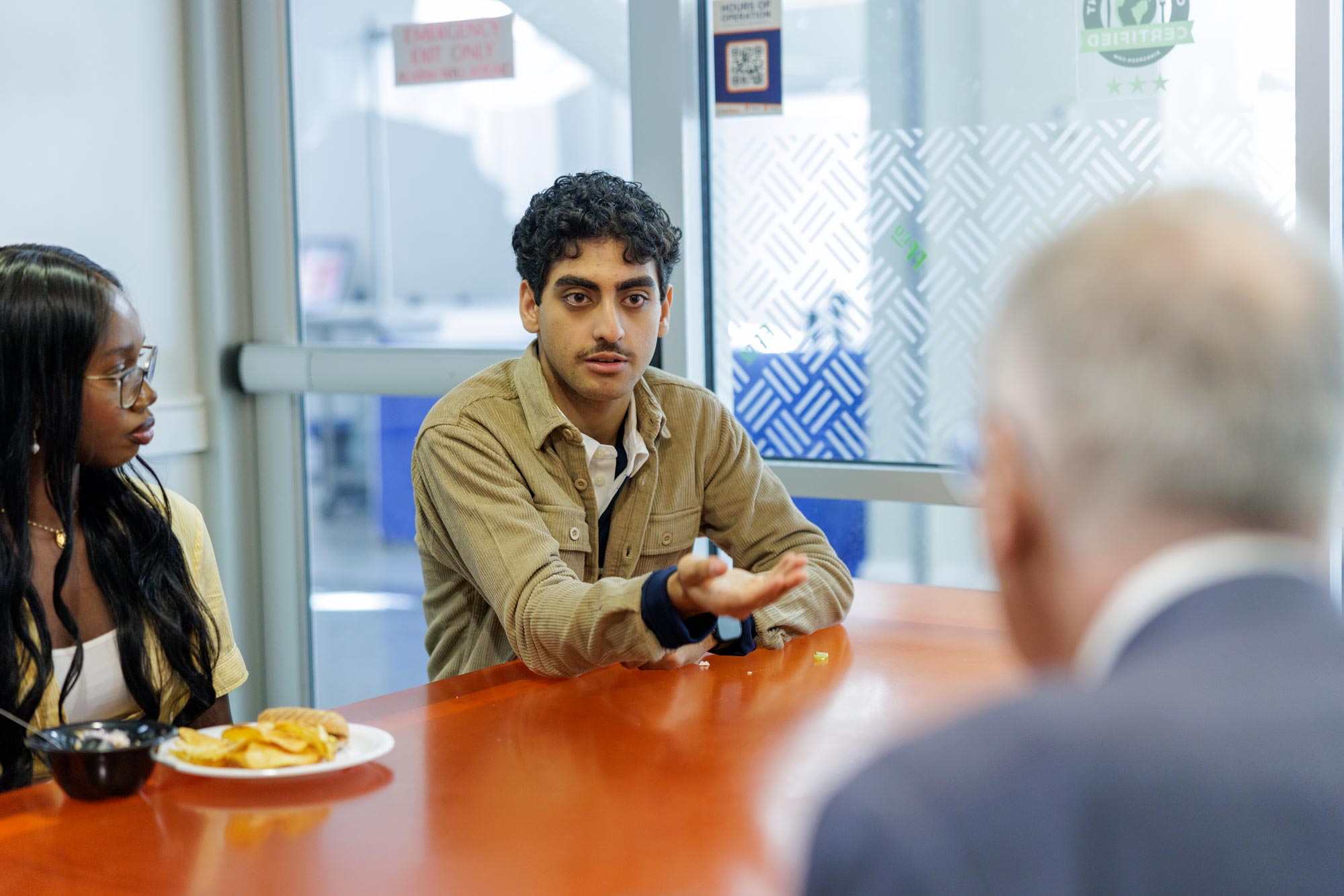 Kiro Ibrahim gestures across the table at Mahoney during the “Table Talk” project.