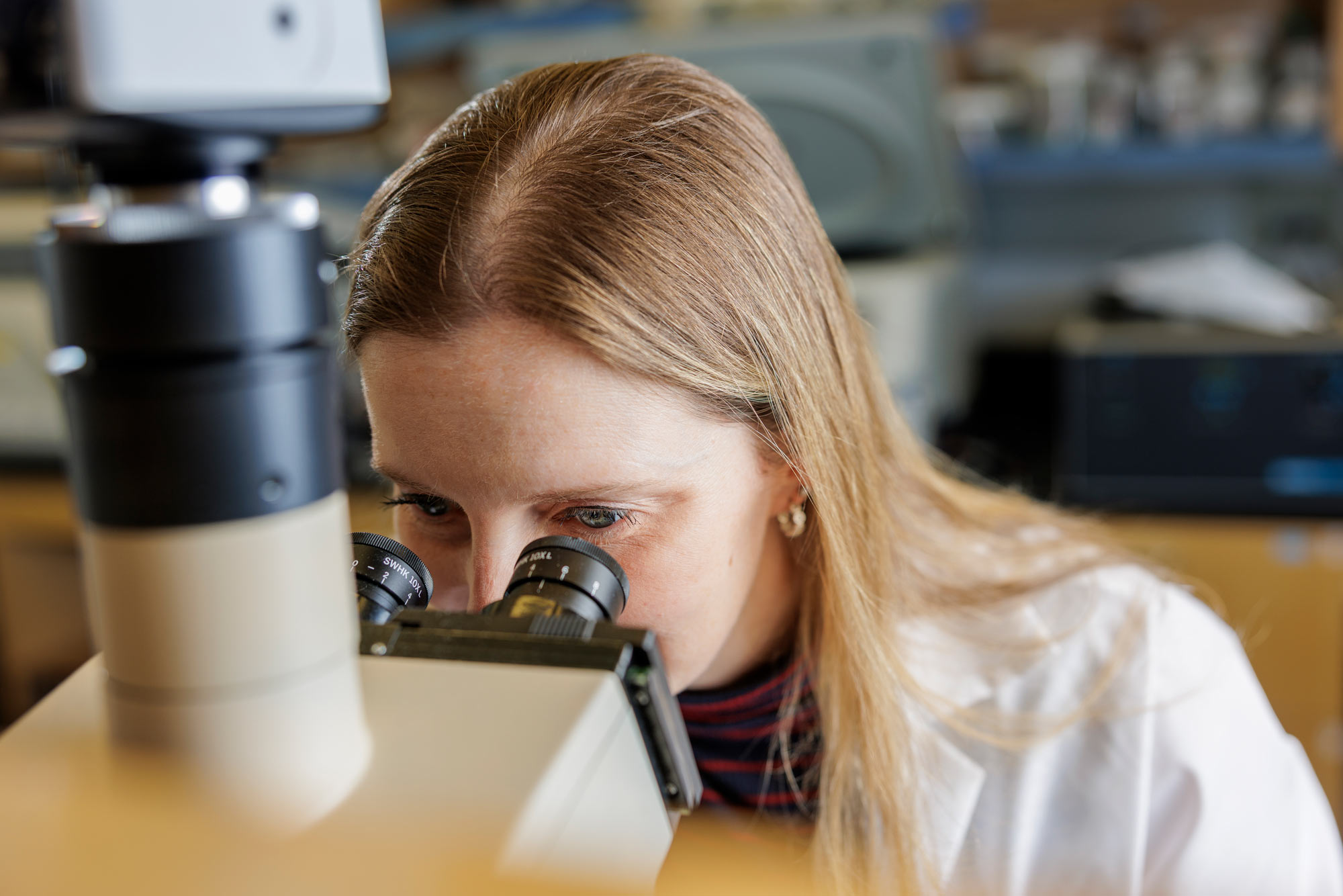 Anderson looking into a microscope.