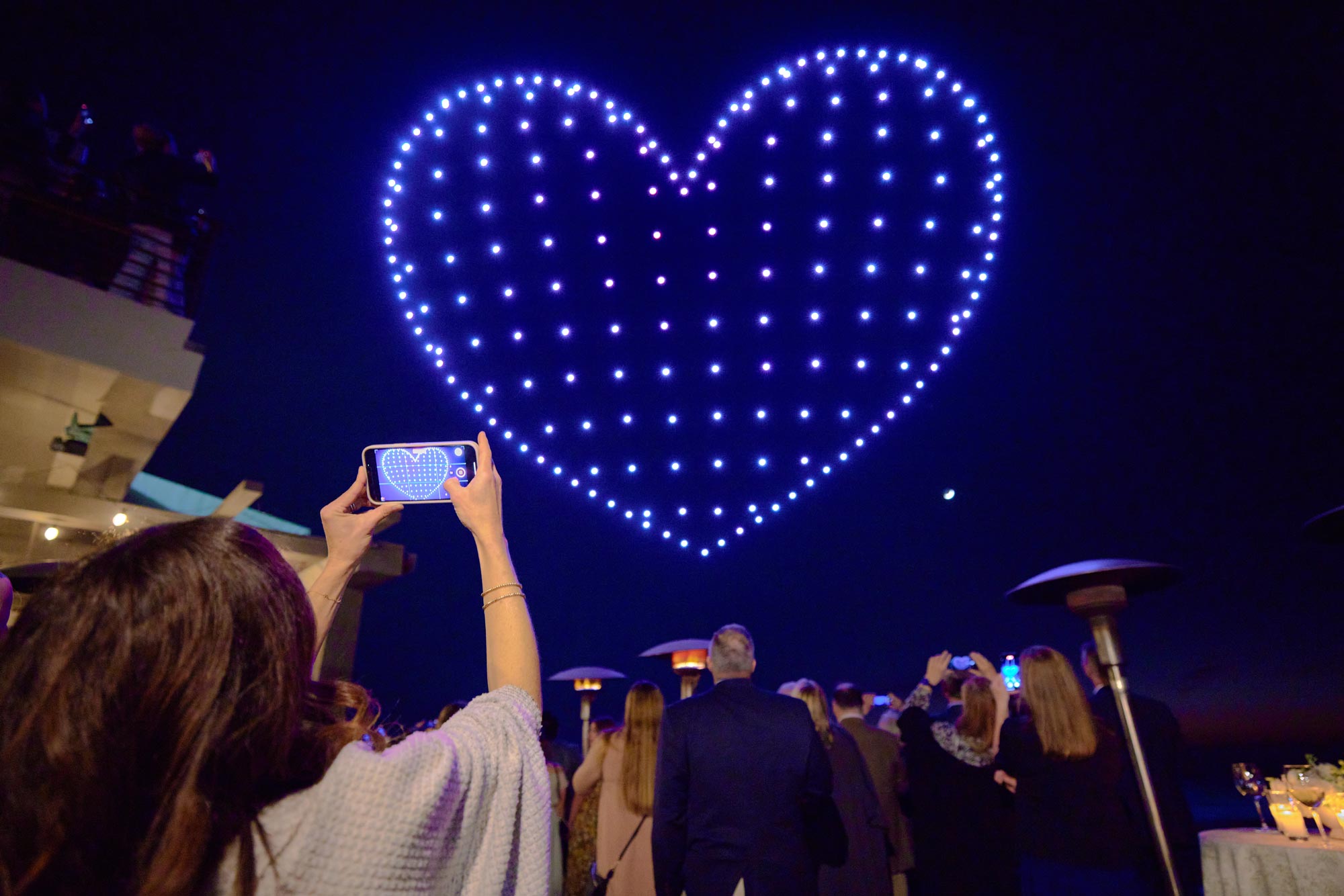 A drone show forming a heart in the sky