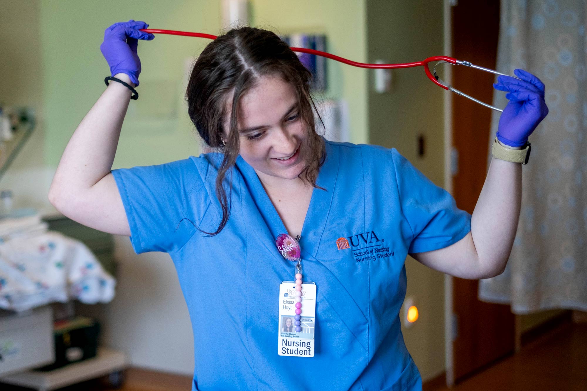 Hoyt putting a stethoscope around her neck