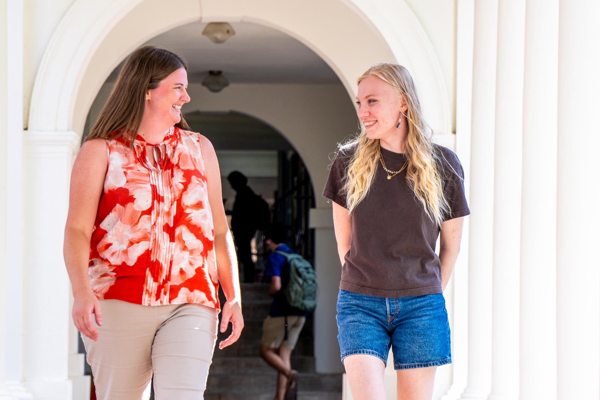 Leah Blue and Mia Martinez walk the corridors on Grounds at UVA