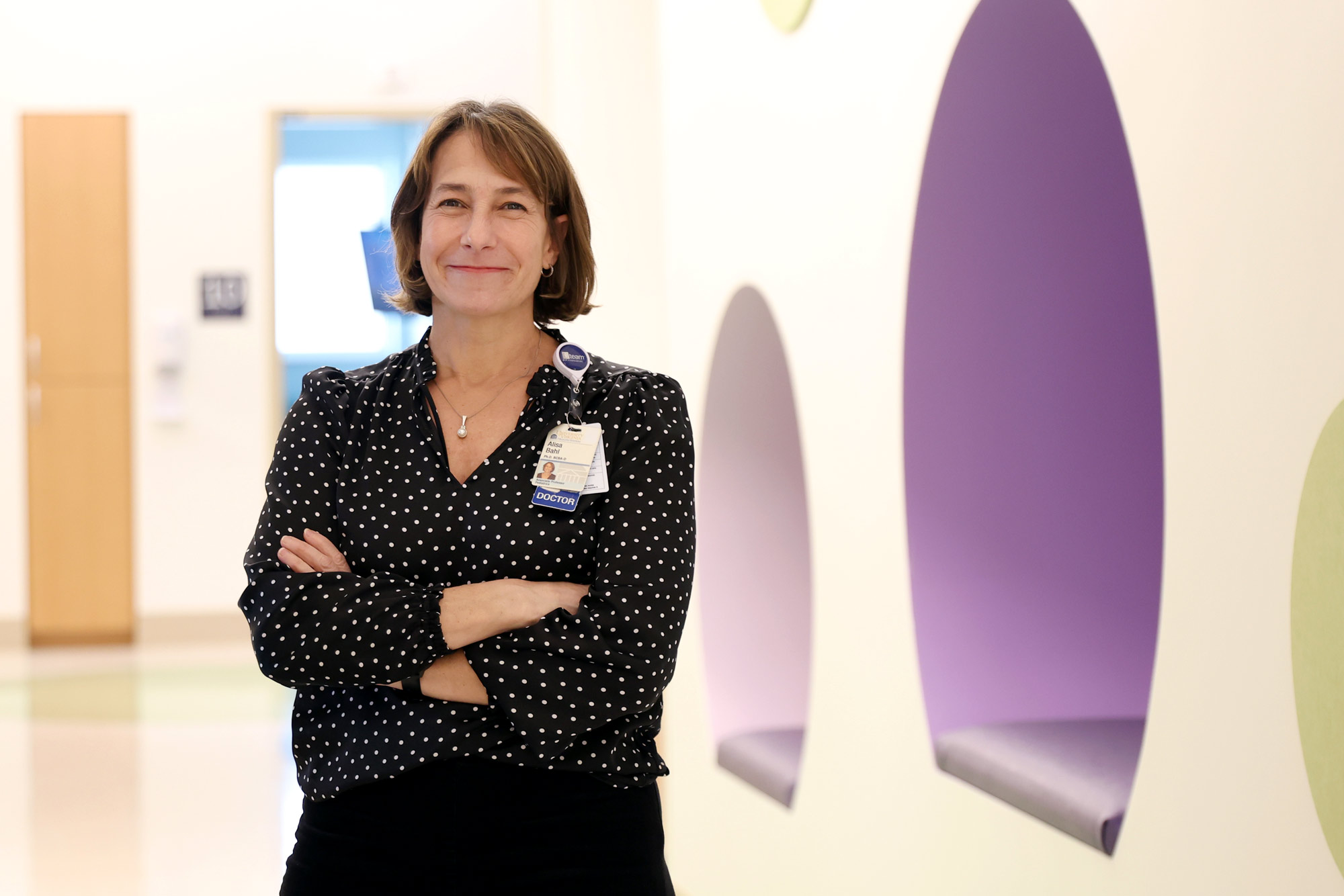 Headshot of UVA associate professor Alisa Bahl, standing in a hospital hallway