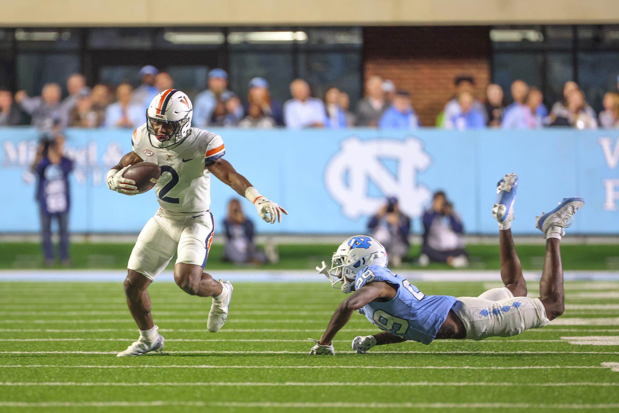 Perris running from a UNC player trying to tackle him on the field