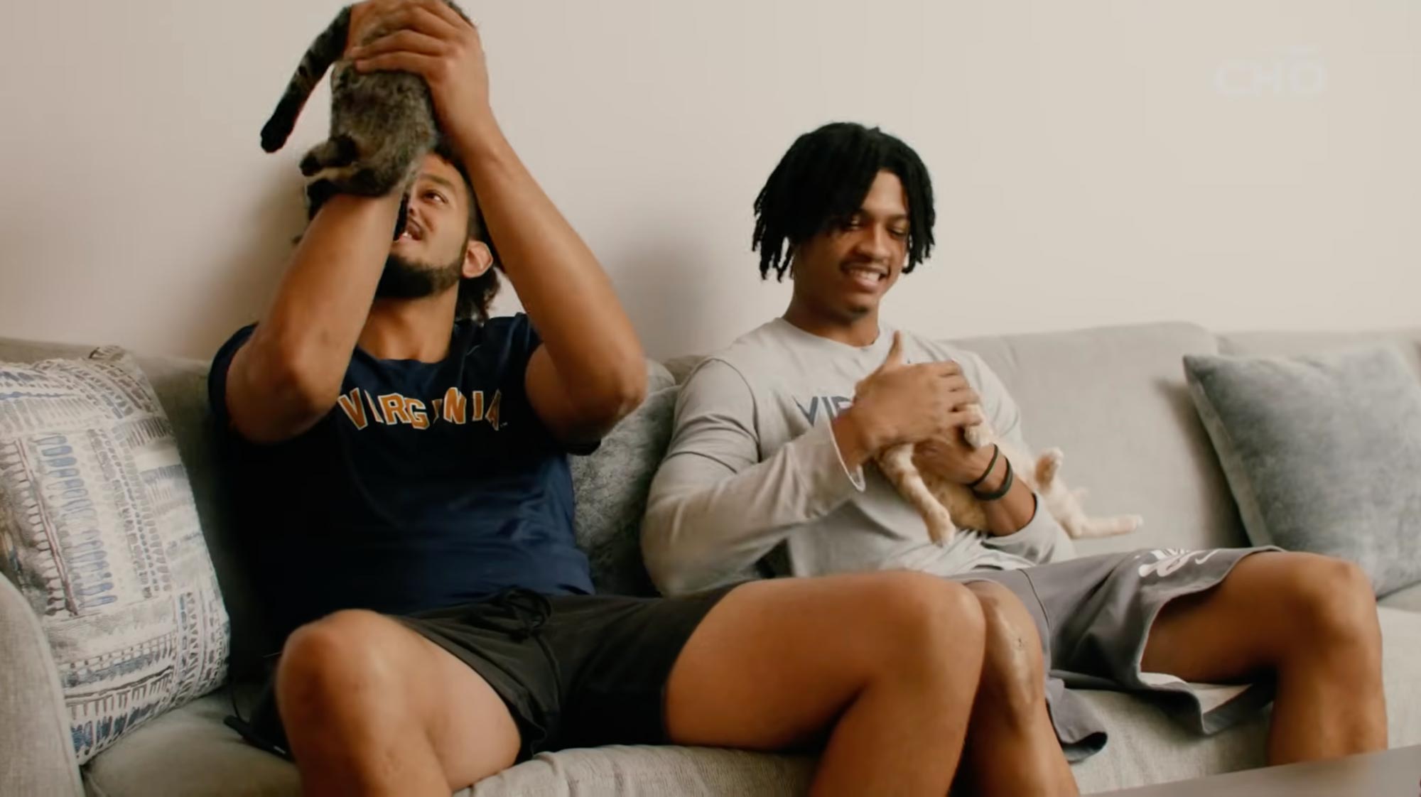 Devin Tillis and Elijah Gertude playing with two kittens