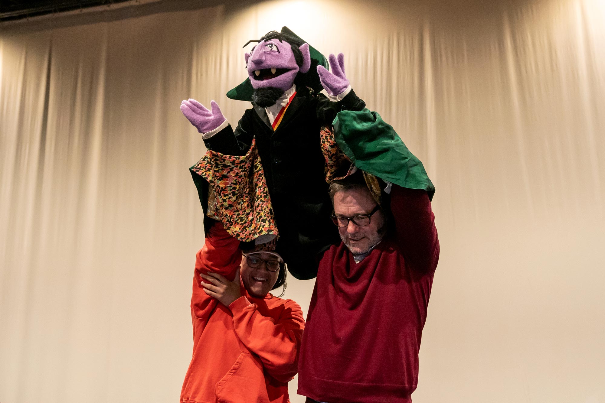 Two puppeteers controlling Count von Count