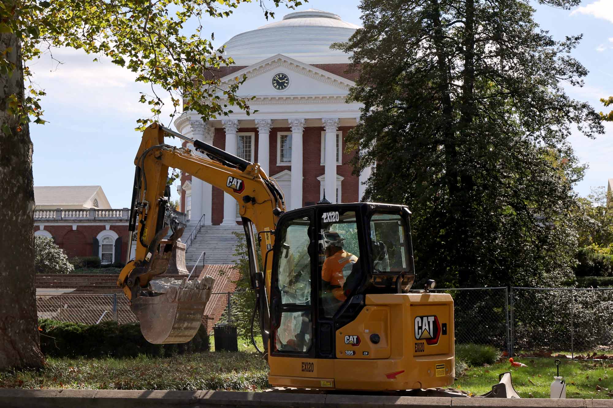 A side angle of the backhoe positioned in front of the Rotunda 