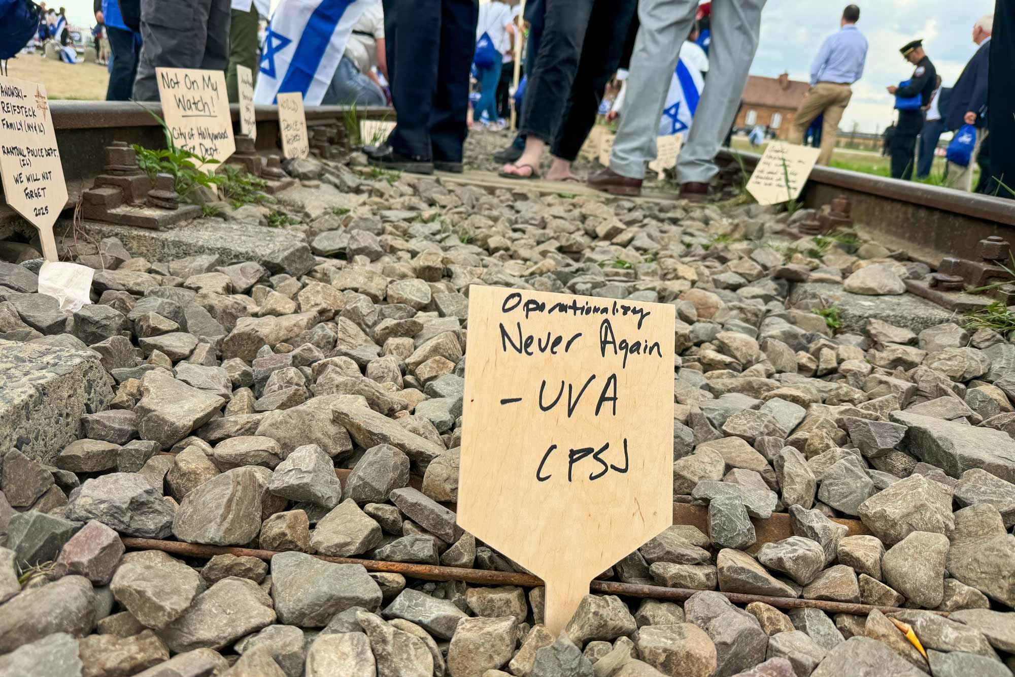 Portrait of Small placards line the railroad tracks leading to World War II labor and death camps Auschwitz and Birkenau.