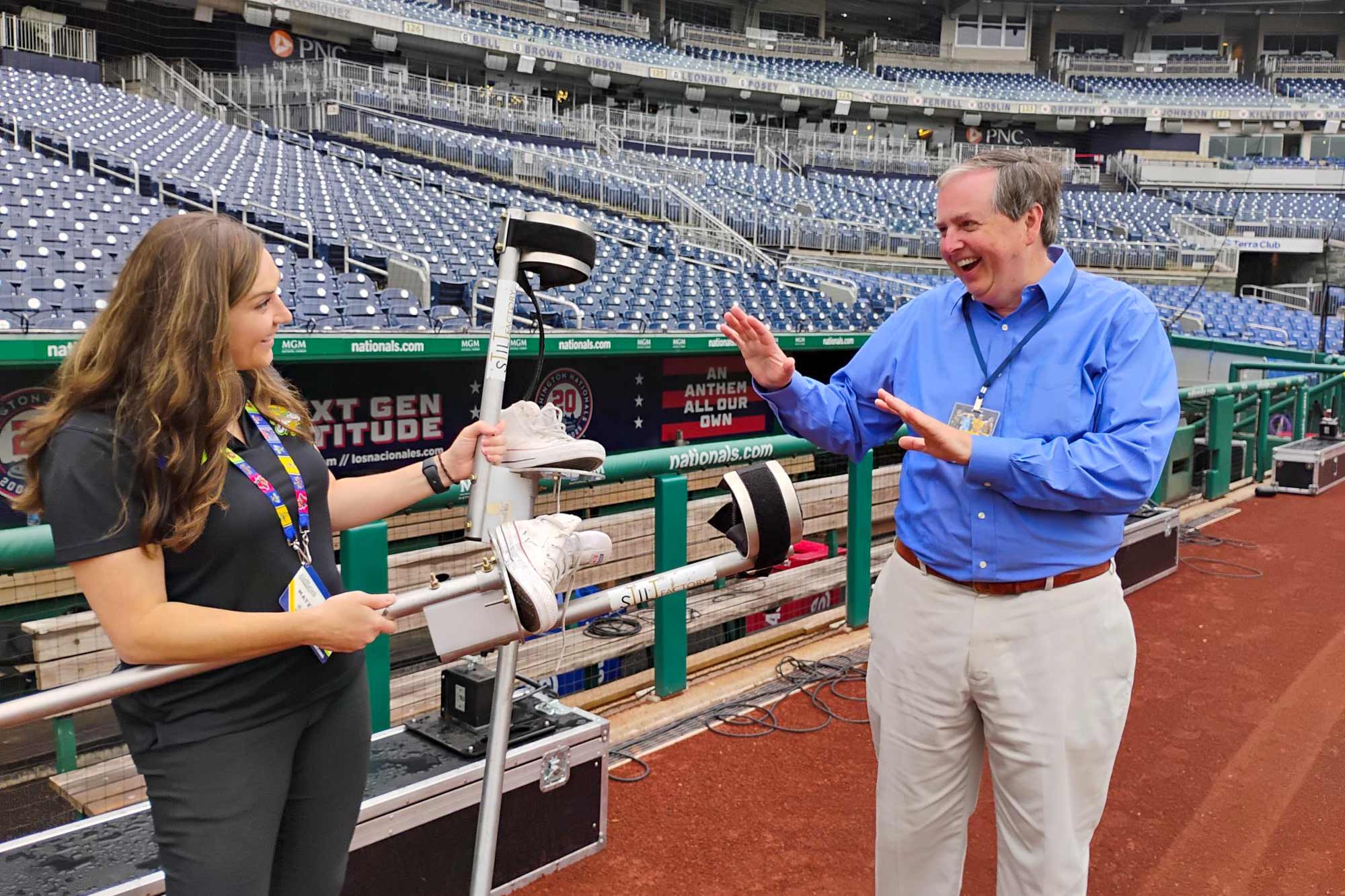 Les Alexander speaking to Marie Matzinger on the field at Nationals Park