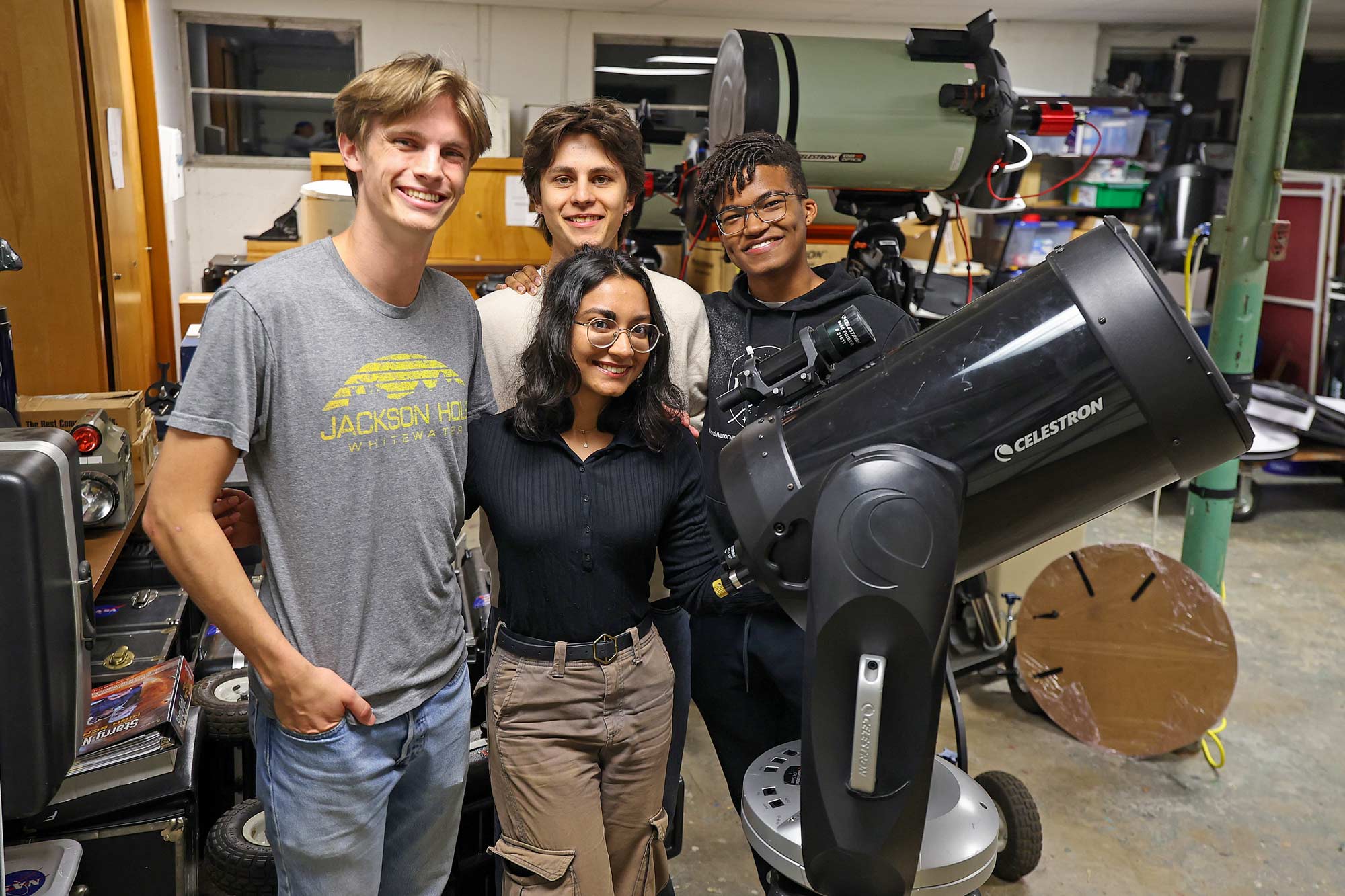 Portrait of Member of the Occultation Group stand with one of their telescopes. From left are Teddy Oakey. Keya Garg (front), Andrey Moore and Altony Foote.