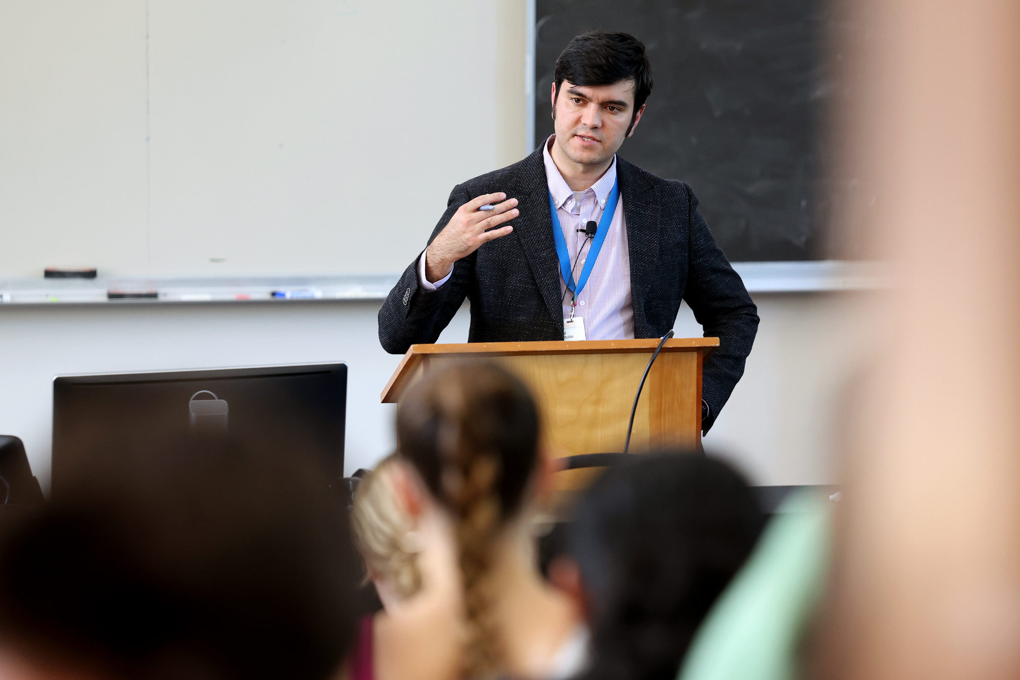 Vlad standing at the front of a classroom giving a lecture