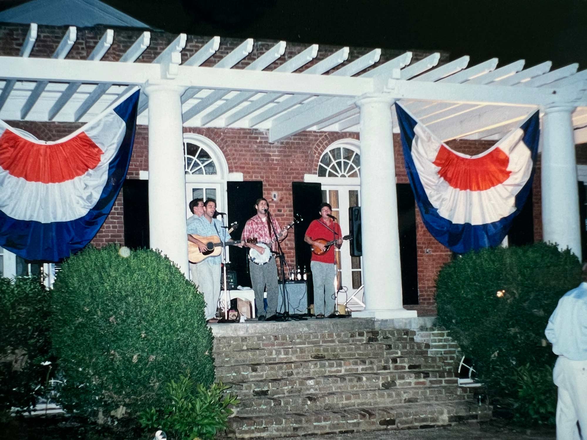 Wrinkle Neck Mules playing a concert behind Pavilion VII on the Lawn at night.