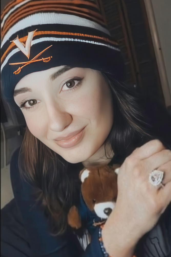 Brittany Toth holding a teddy bear and wearing a UVA beanie