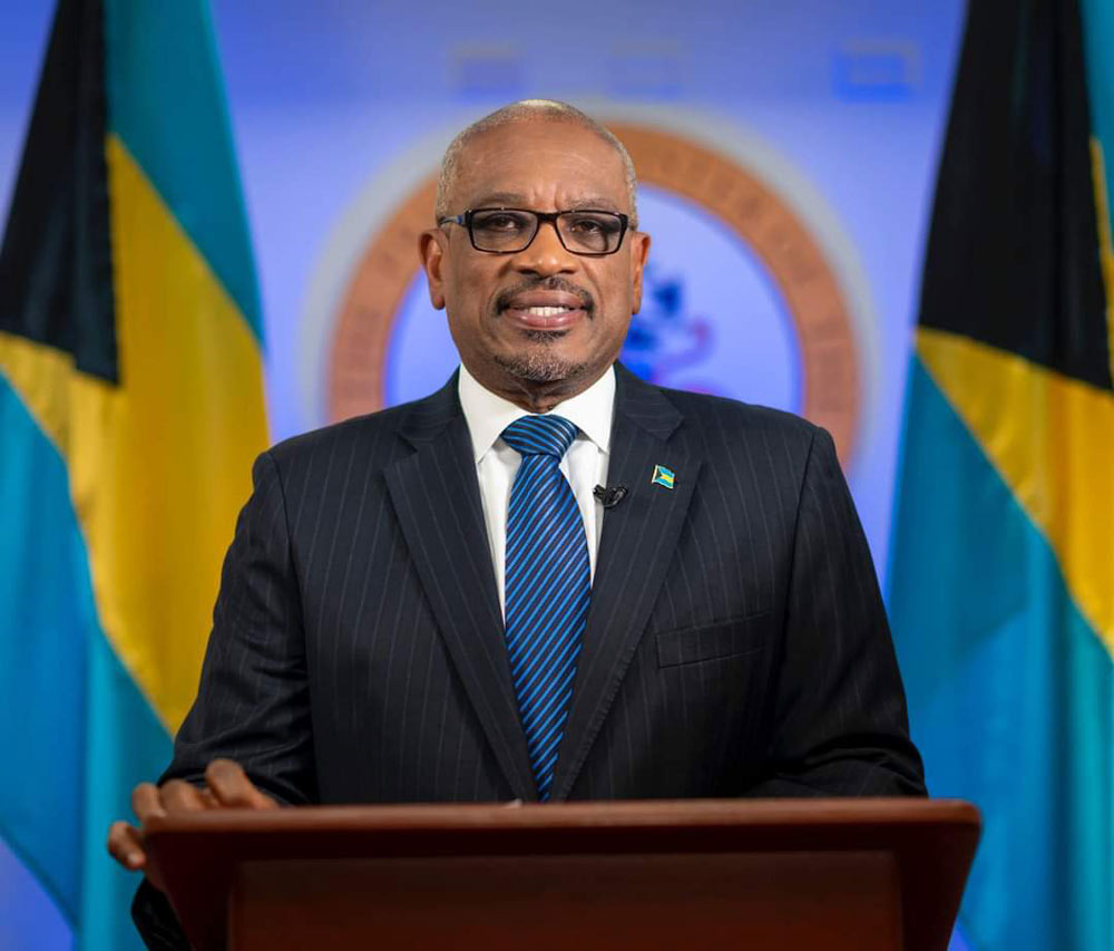 Minnis, the prime minister of the Bahamas stands at a podium