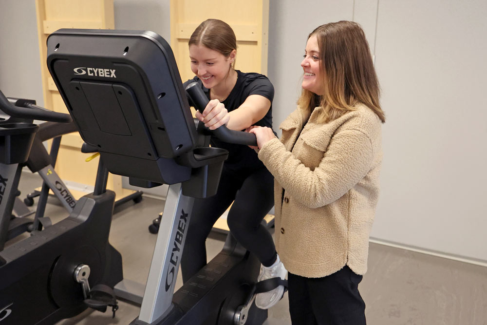 Lead researcher Kara Anderson monitors colleague Macy Stahl’s progress on an exercise bike 