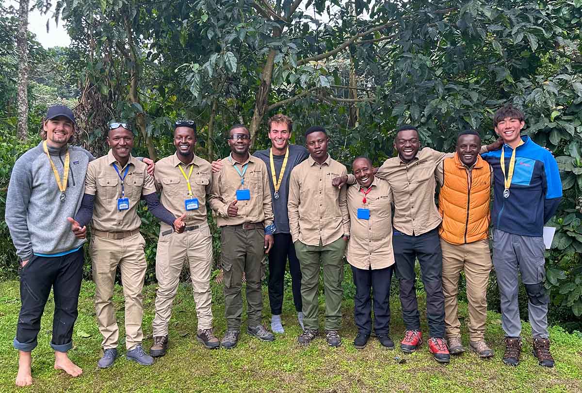 Kevin Lee, James Edwards and Tommy McNeal stand with a Tanzanian tour guide group