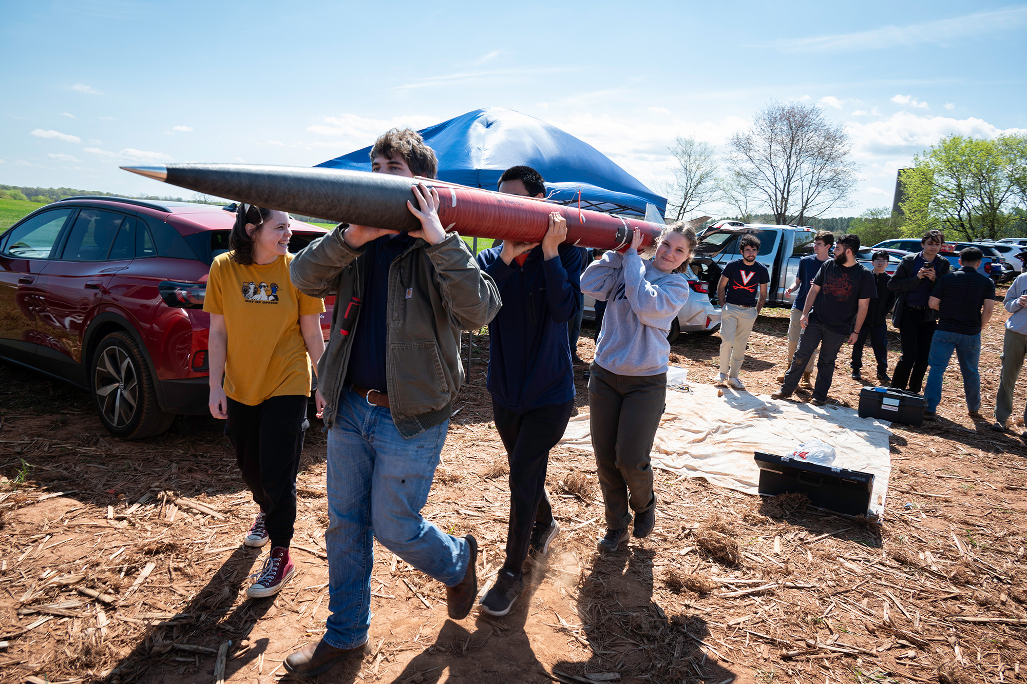 Anderson Garner, Edison Wong and James Phelps carrying their rocket.