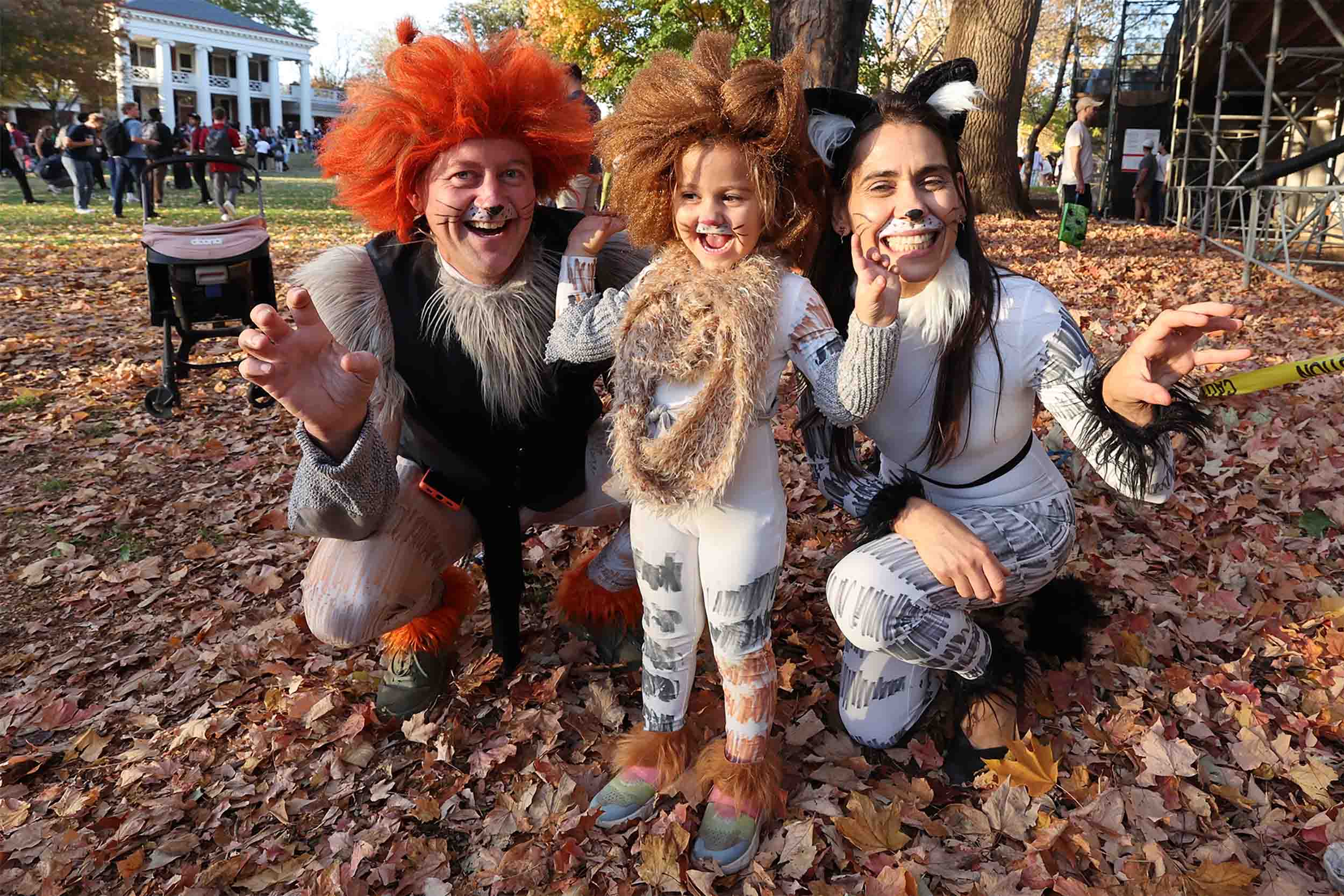 Parents and child dressed as different cats