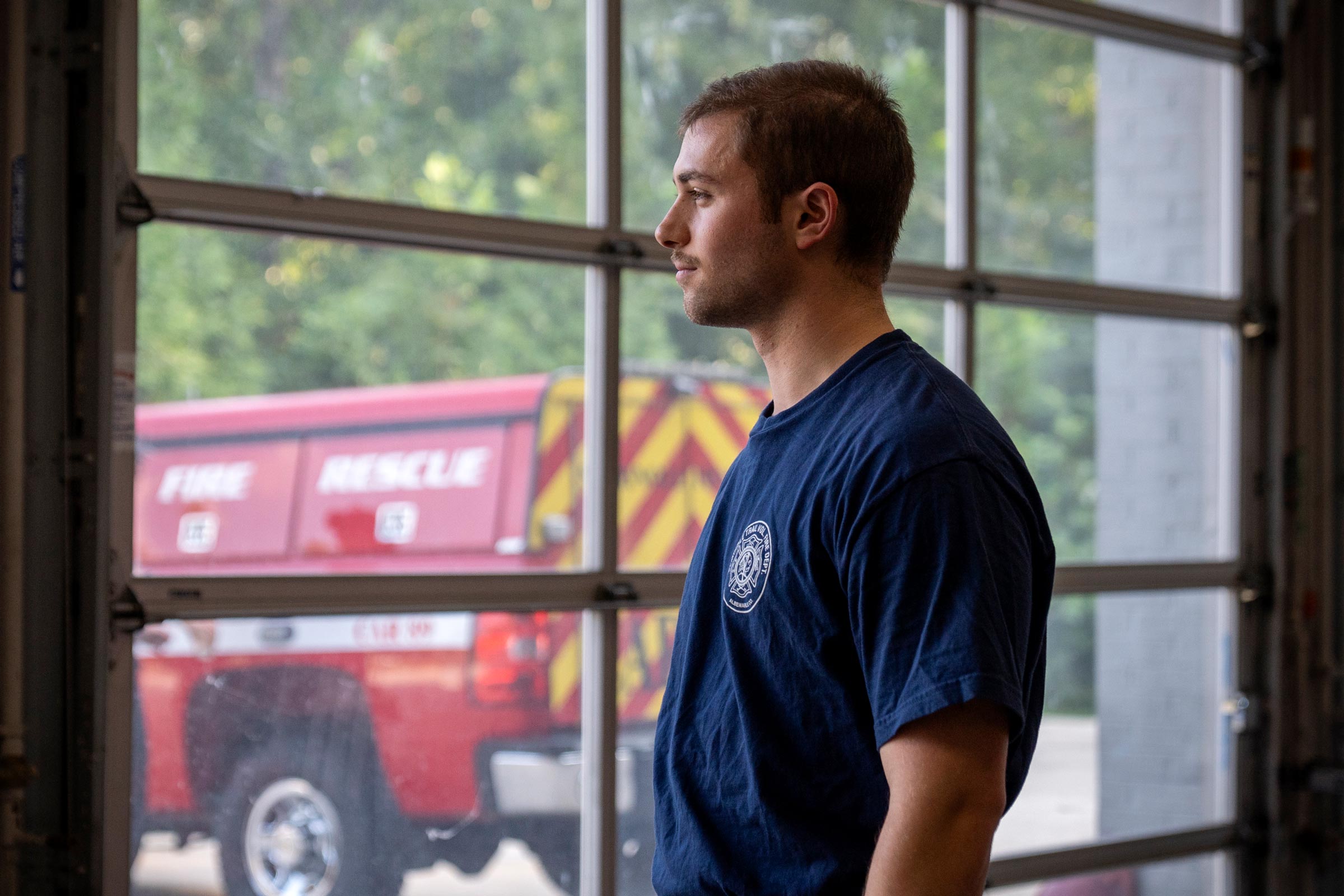 Firefighter Green looks out of the bay garage window