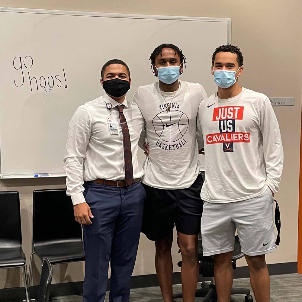 Portrait of Isaiah Swann (left) and Jayden Nixon (center) attend an Athletes in Medicine event at John Paul Jones Academic Center