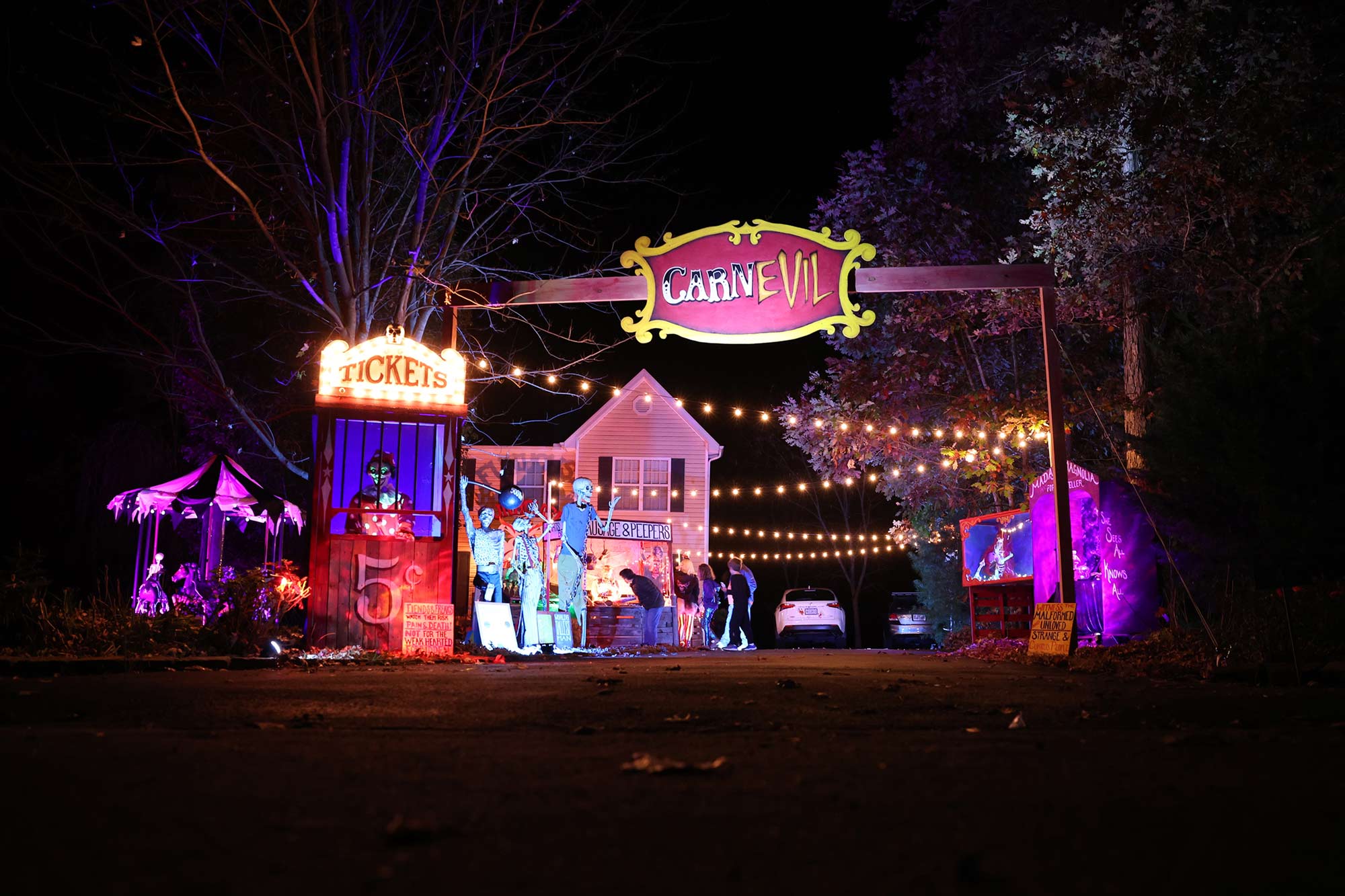 The entrance to the evil carnival themed yard full of lights and signs.