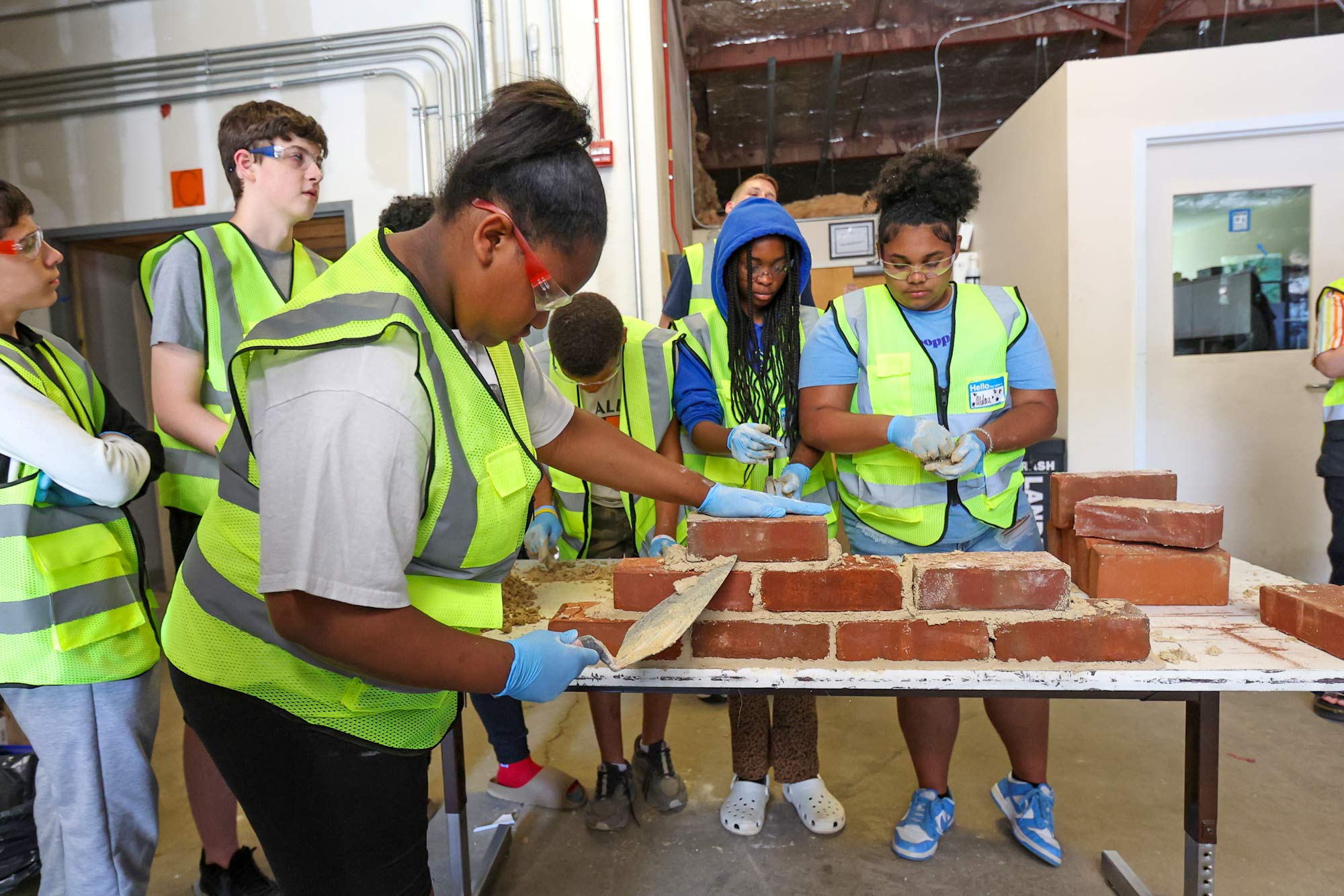 Students learning masonry