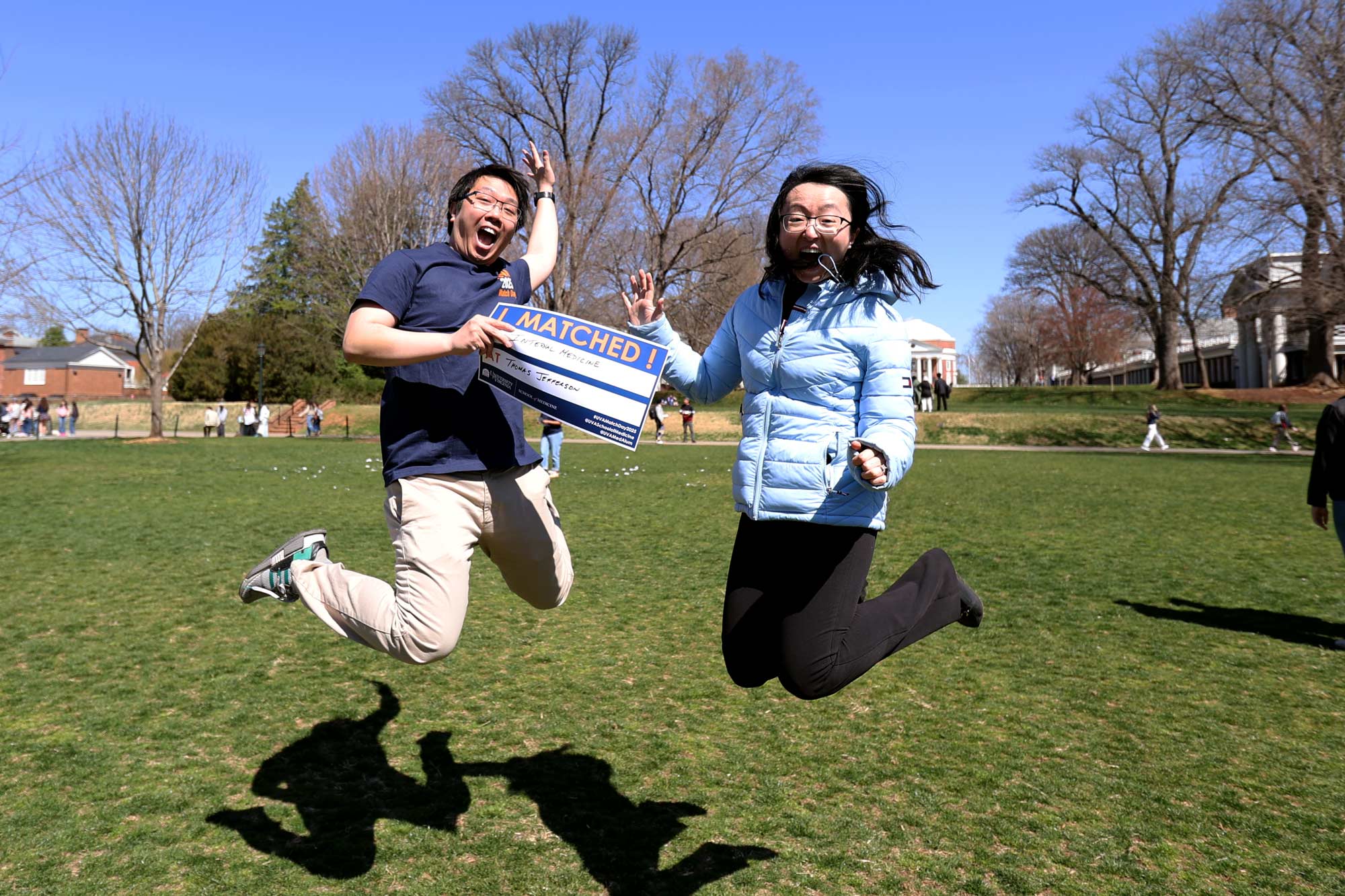 UVA medical student Davis Tran jumping in the air with joy