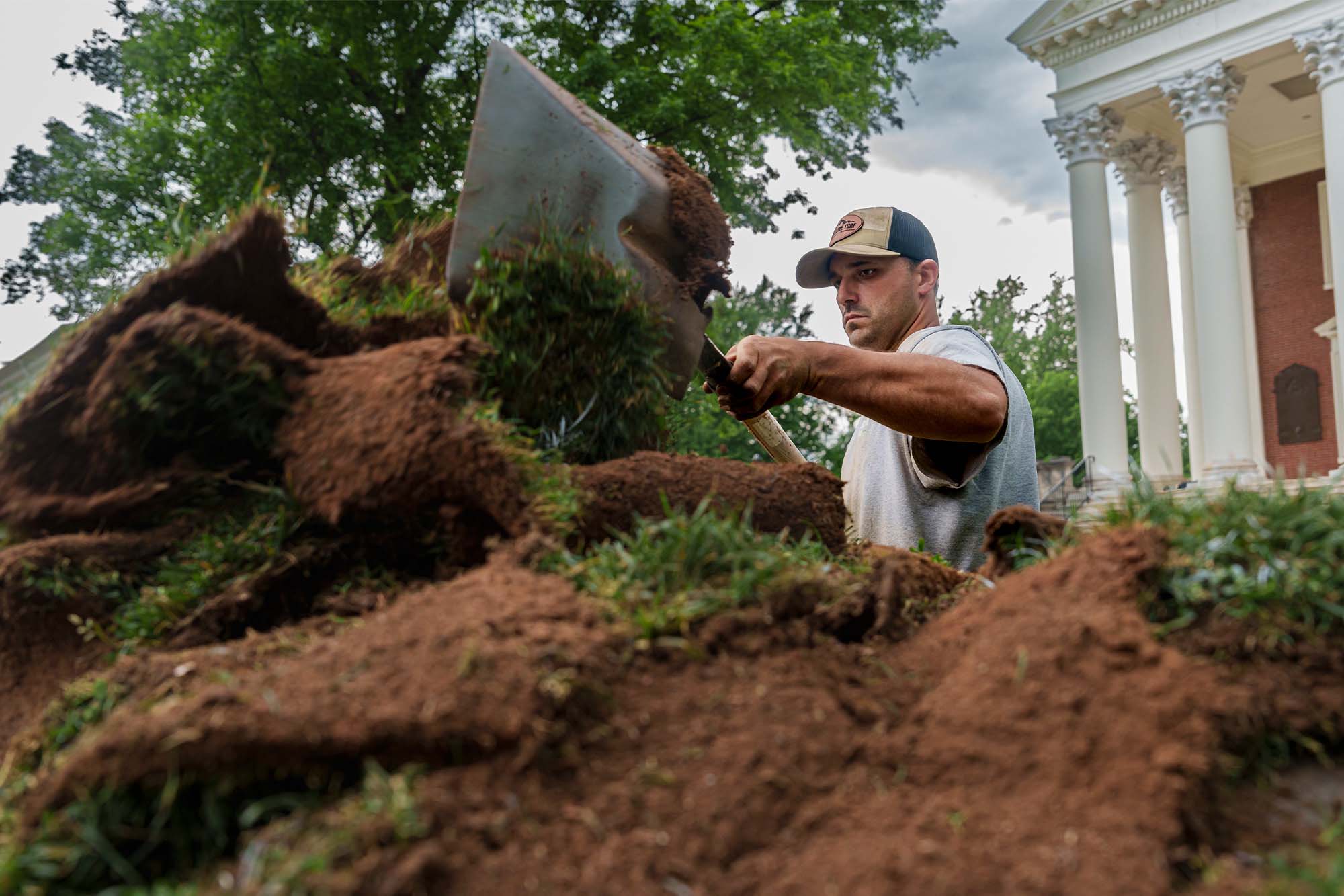 Motto shoveling up sod on the Lawn