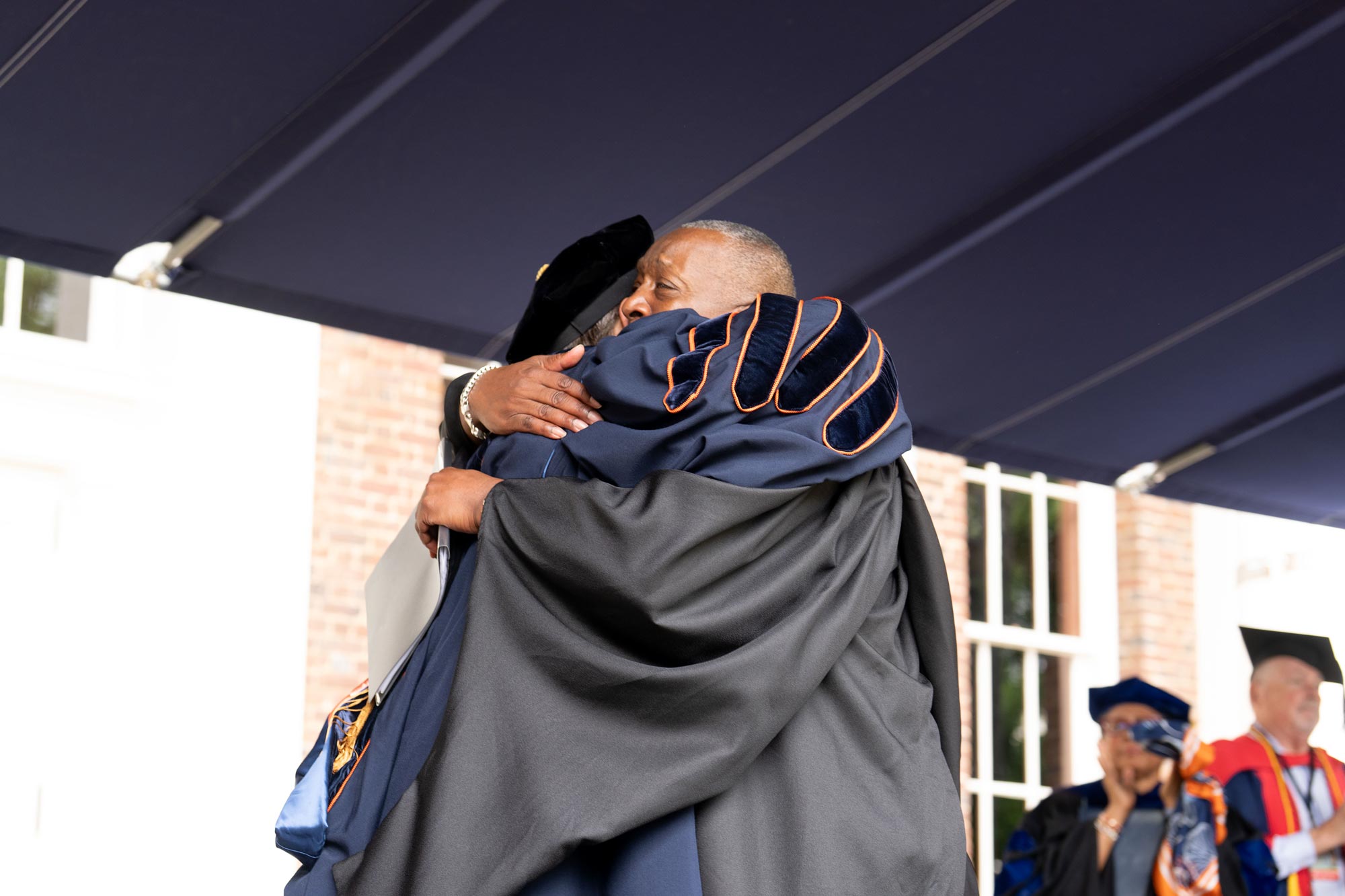 UVA President Jim Ryan and Cedric Rucker hugging at the end of Cedric‘s speech