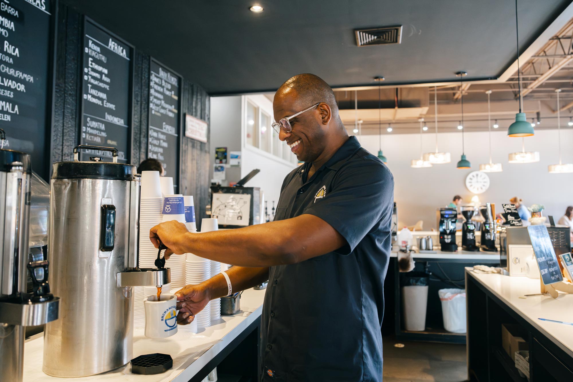 Pacheco pouring a cup of coffee