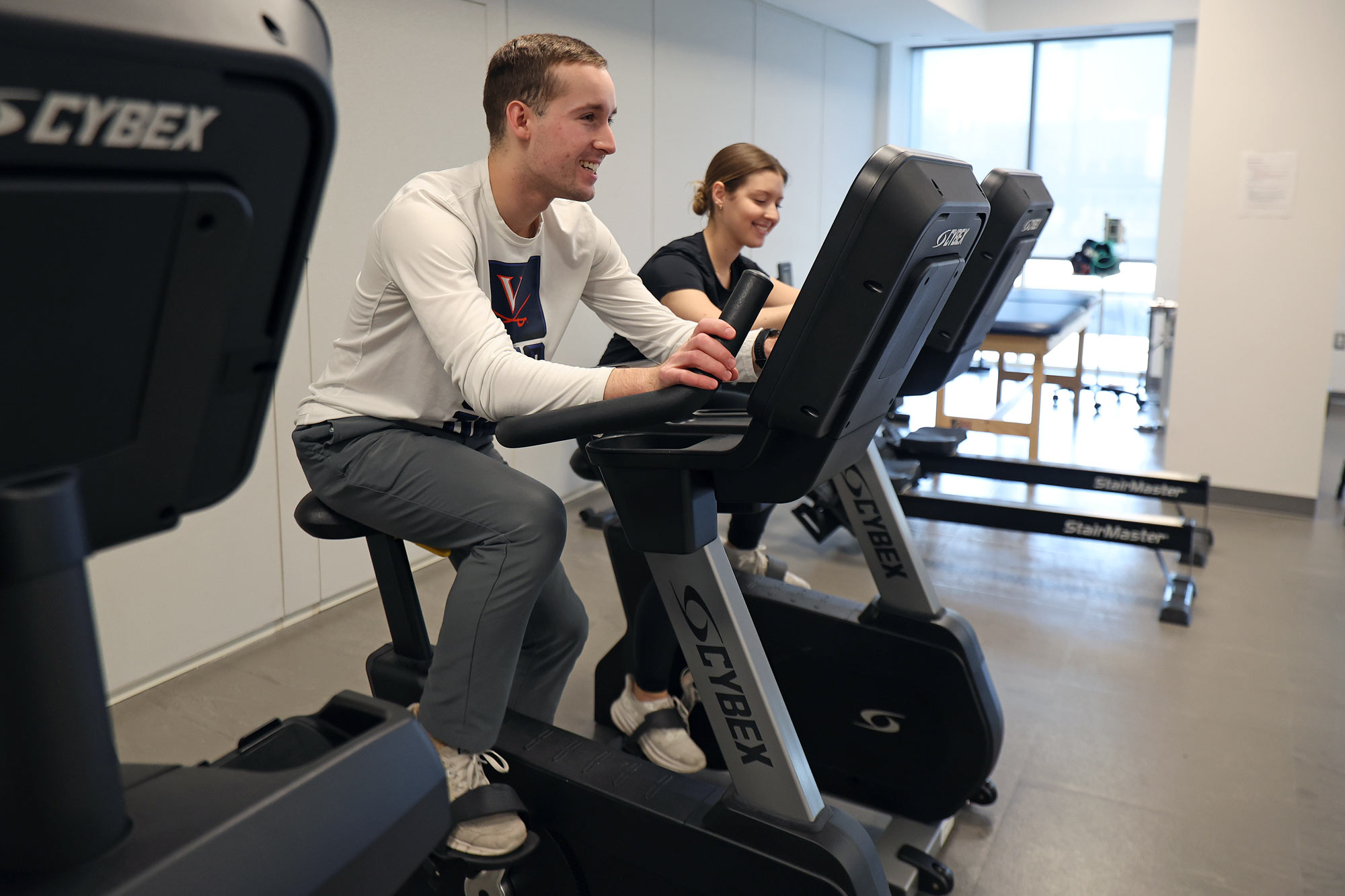 Research team members Benjamin Stephenson and Macy Stahl race on the exercise bikes, adding intensity to their workouts.