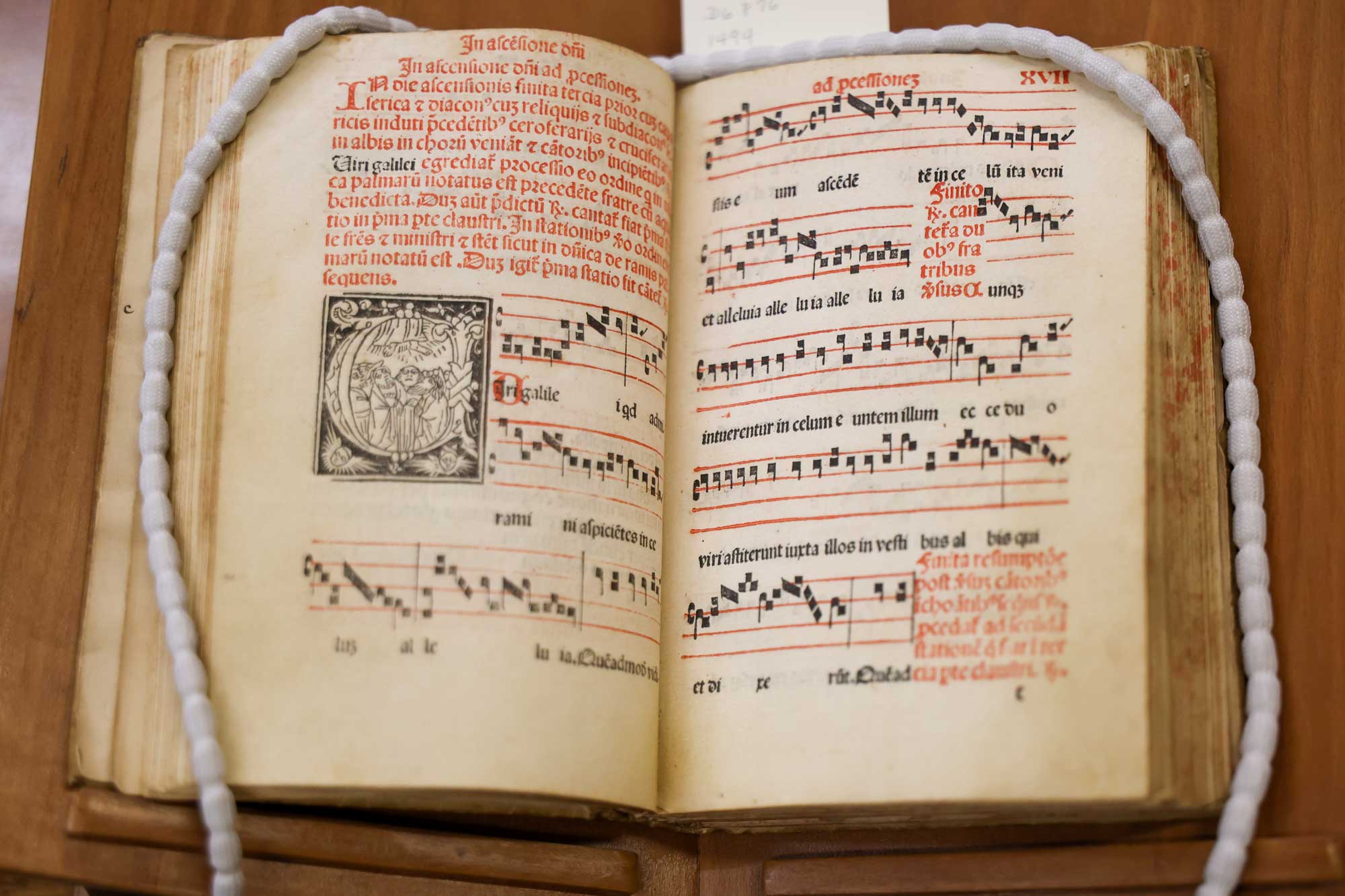 an incunabula holding a music book written in Latin open to a hymn