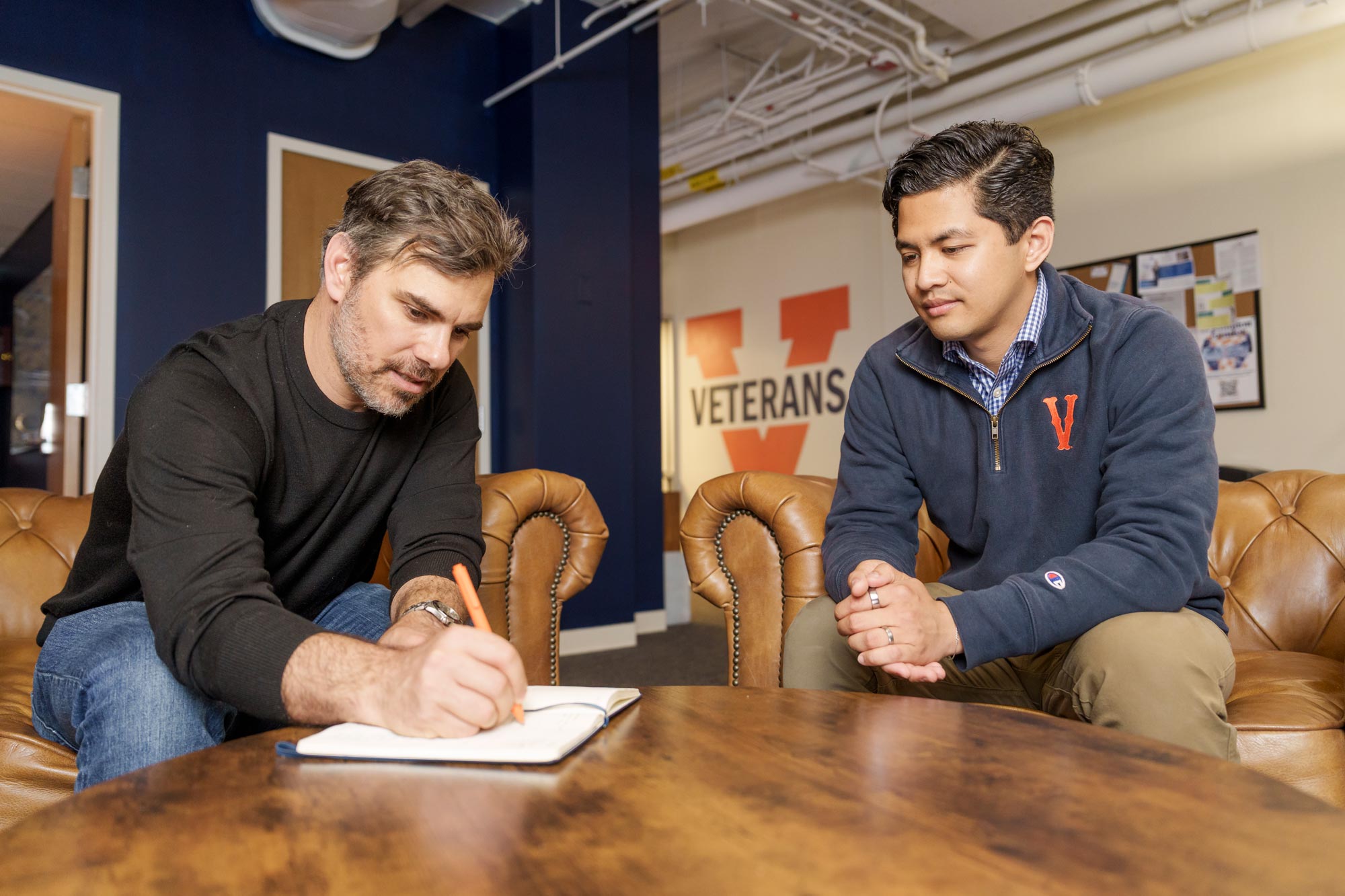 Candid of Romeo Sarmiento and Mike Rose working in the Veteran Student Center in Newcomb Hall